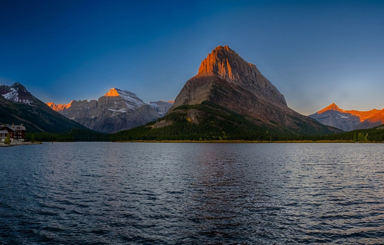 Wallpaper autumn, forest, the sky, trees, sunset, mountains, lake, rocks, home, USA, Glacier National Park, Montana, Swiftcurrent Lake image for desktop, section пейзажи