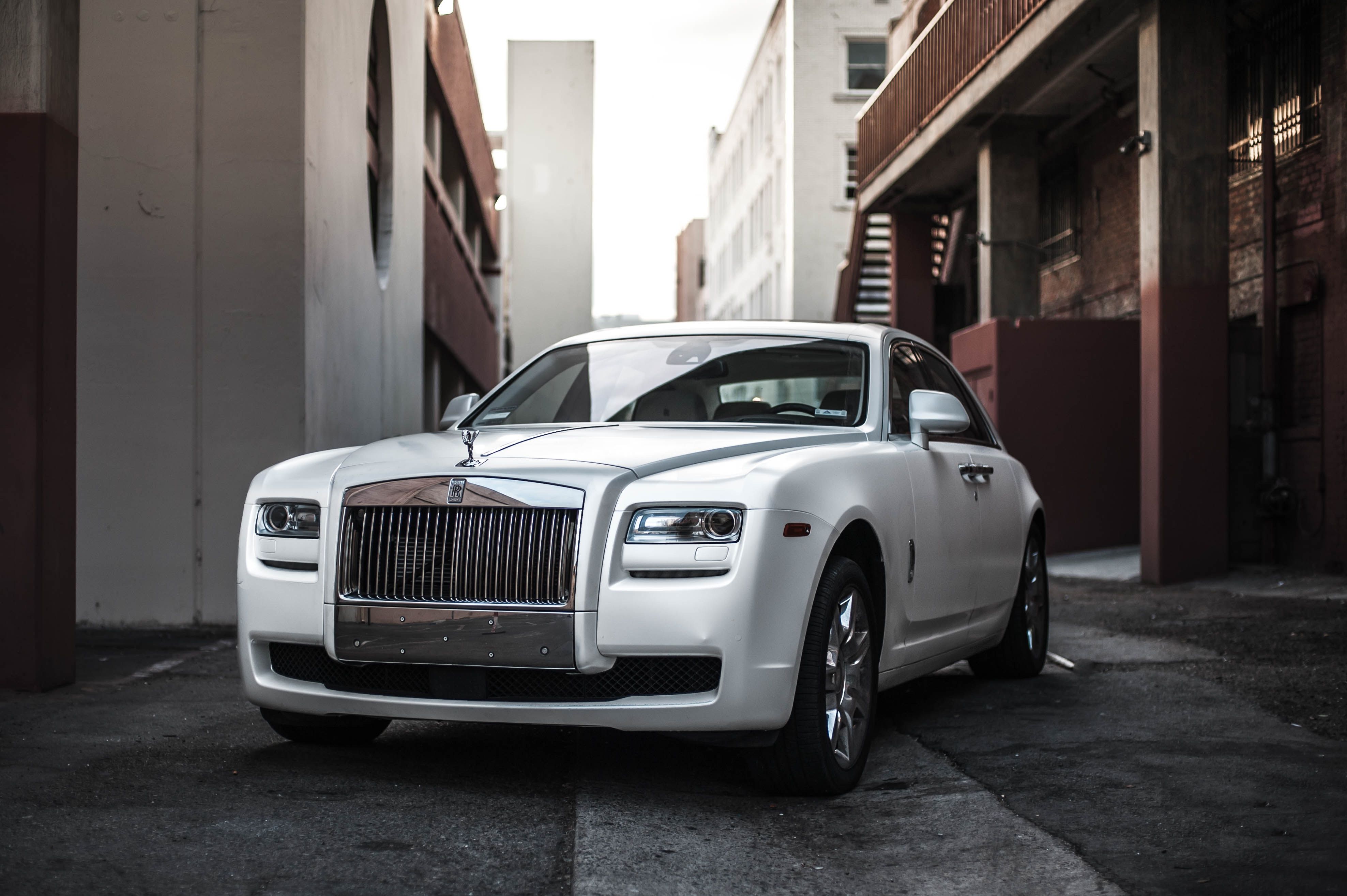 Photo of White Rolls Royce Ghost Parked in an Alley · Free