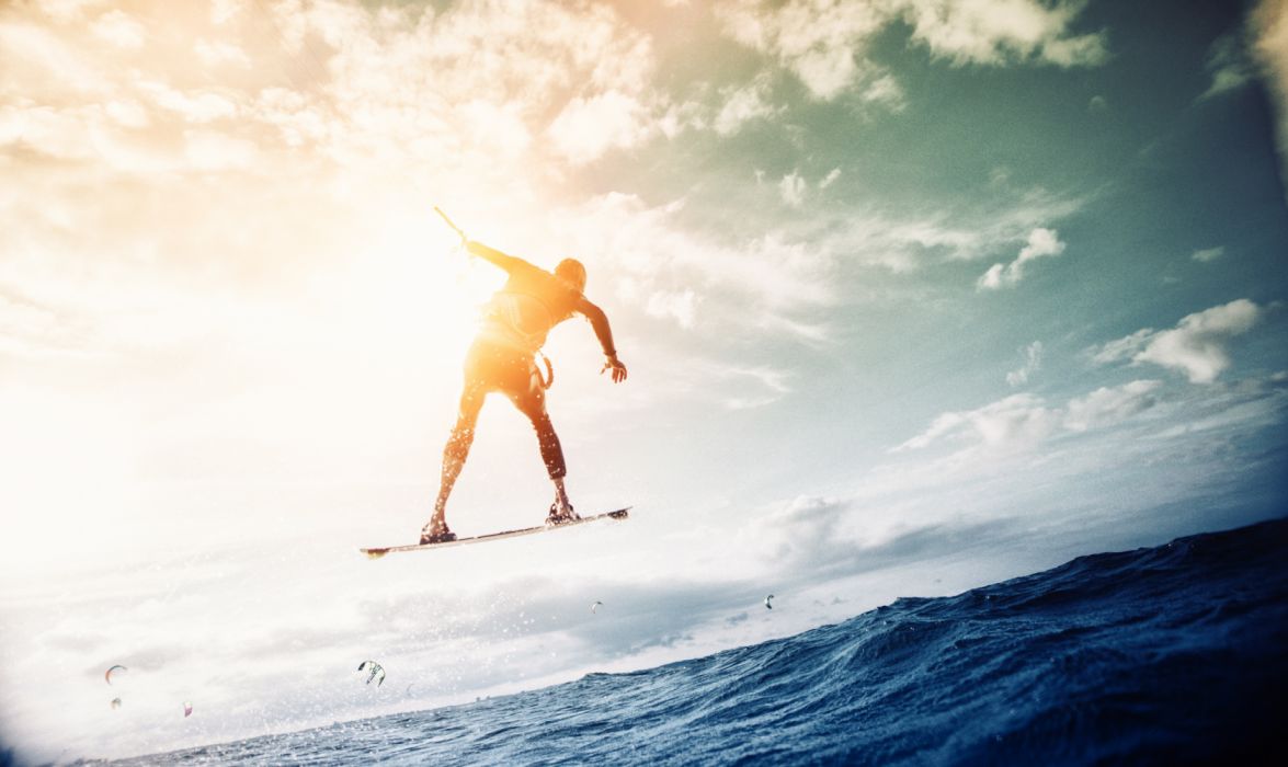 Man Wakeboarding over Body of Water wallpaperx3336