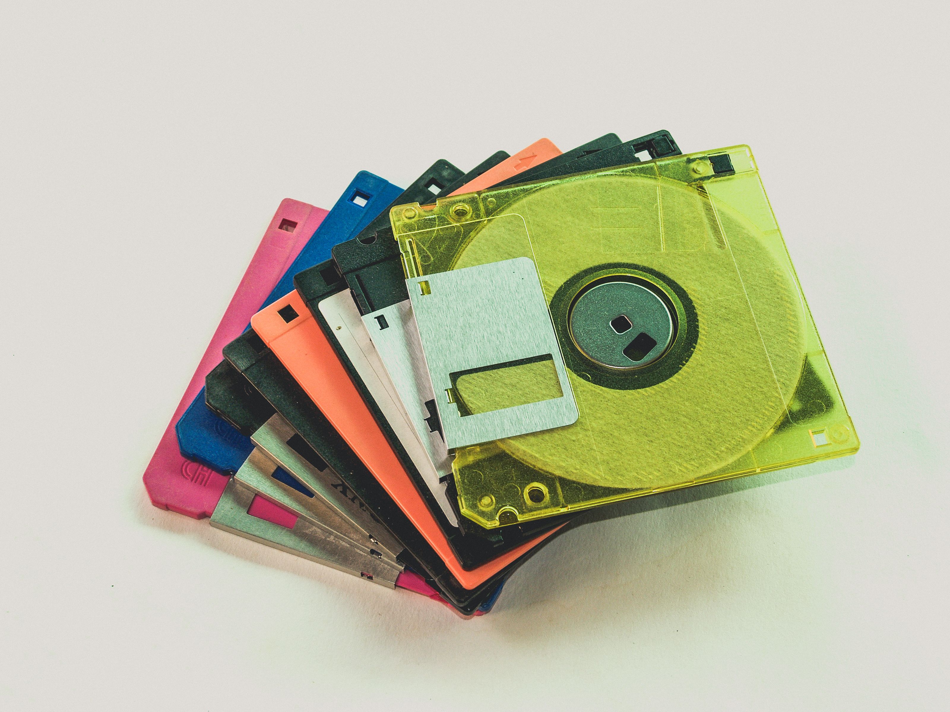 Floppy Disk Lot on White Surface · Free