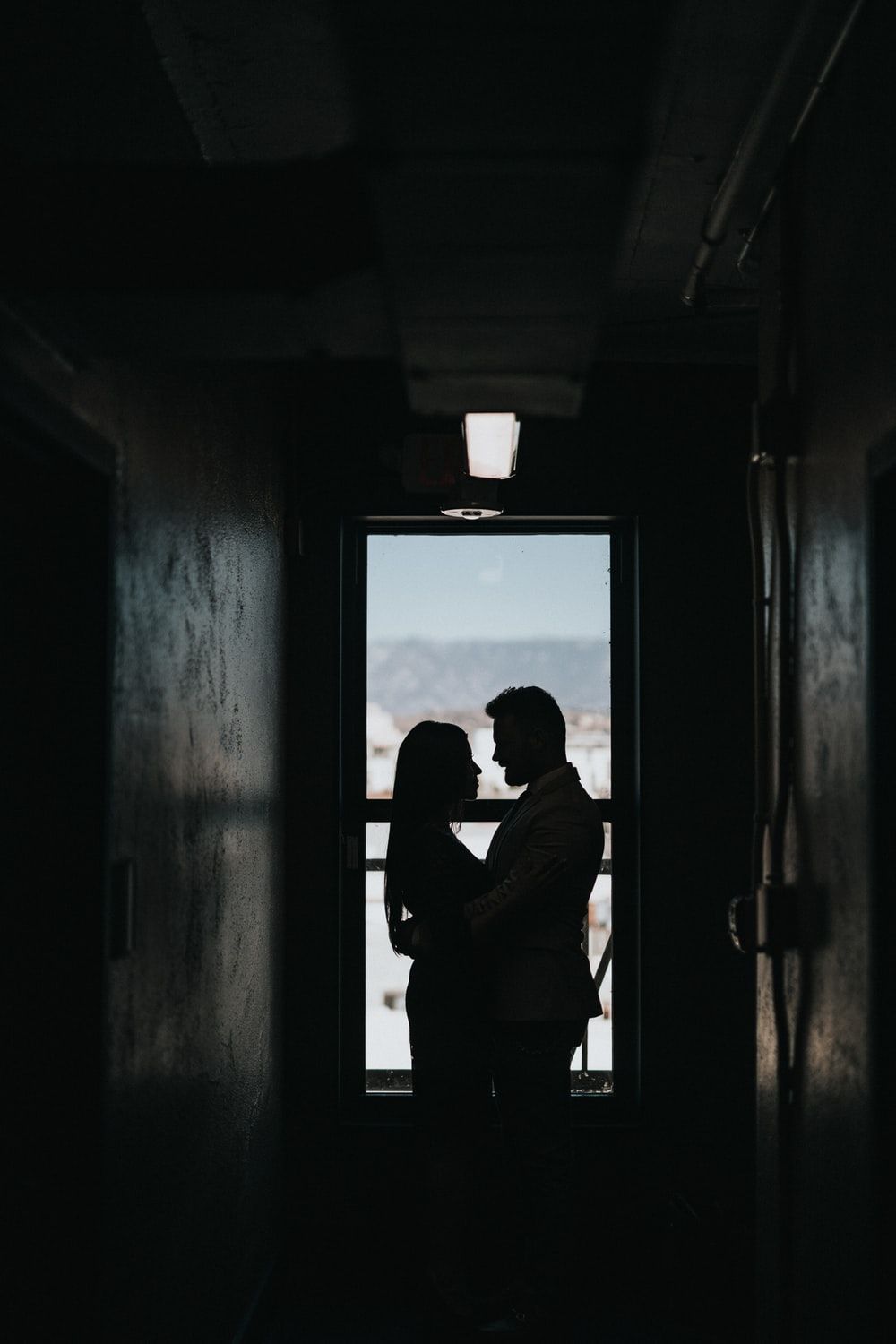 silhouette of couple inside dark room photo