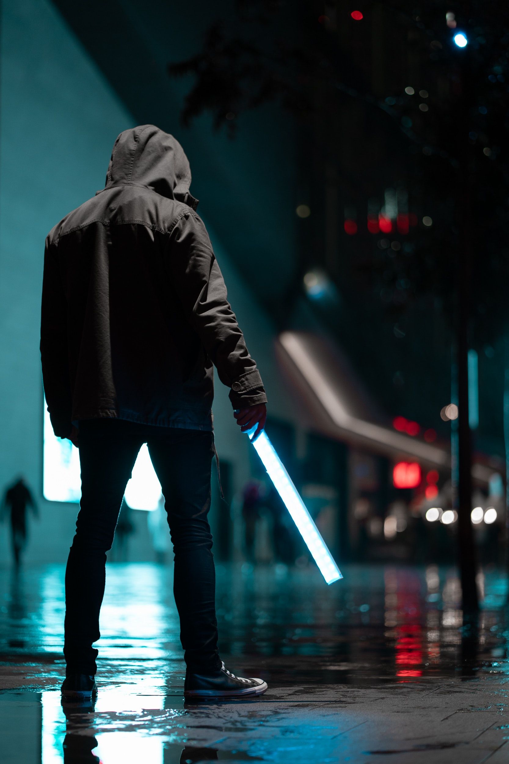 Man Wearing Black Hoodie Standing on Concrete Pavement at Night · Free