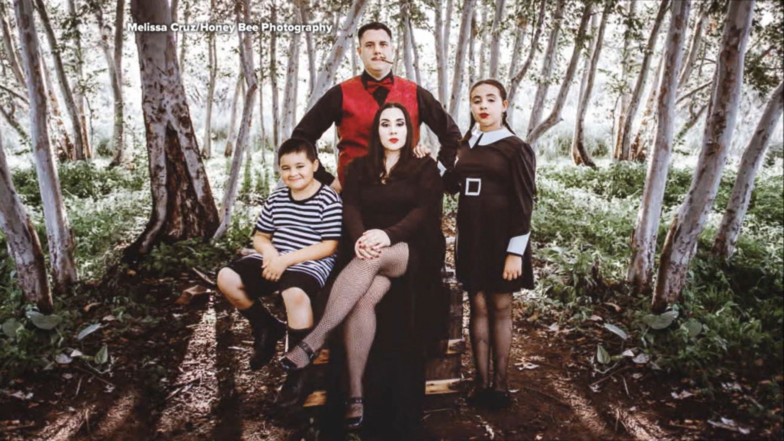 Family poses for creepy, kooky 'Addams Family'-themed Halloween photo