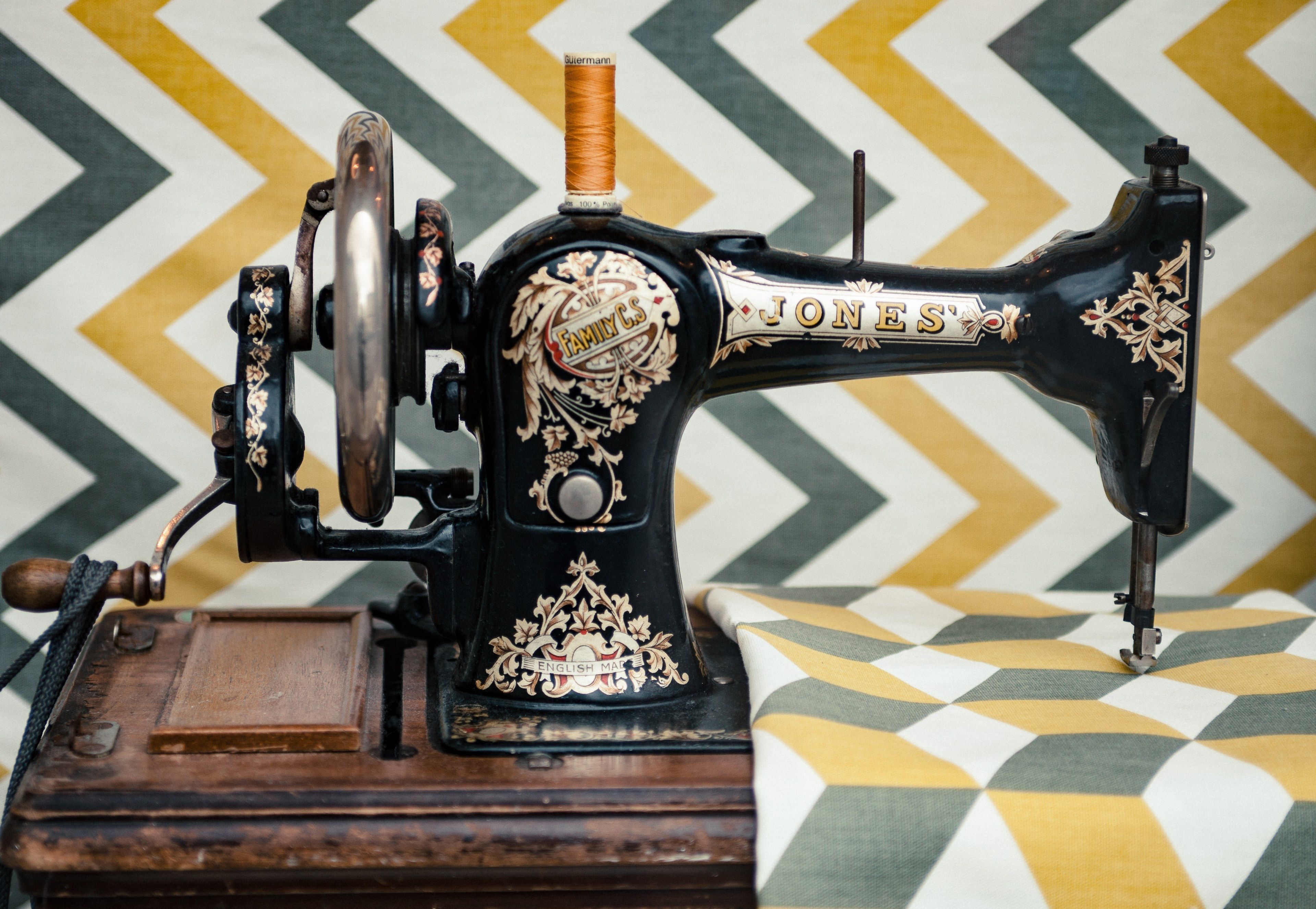 Wallpaper / the side view of an old vintage sewing machine sewing on a patterned fabric in cambridge, _vintage sewing machine 4k wallpaper