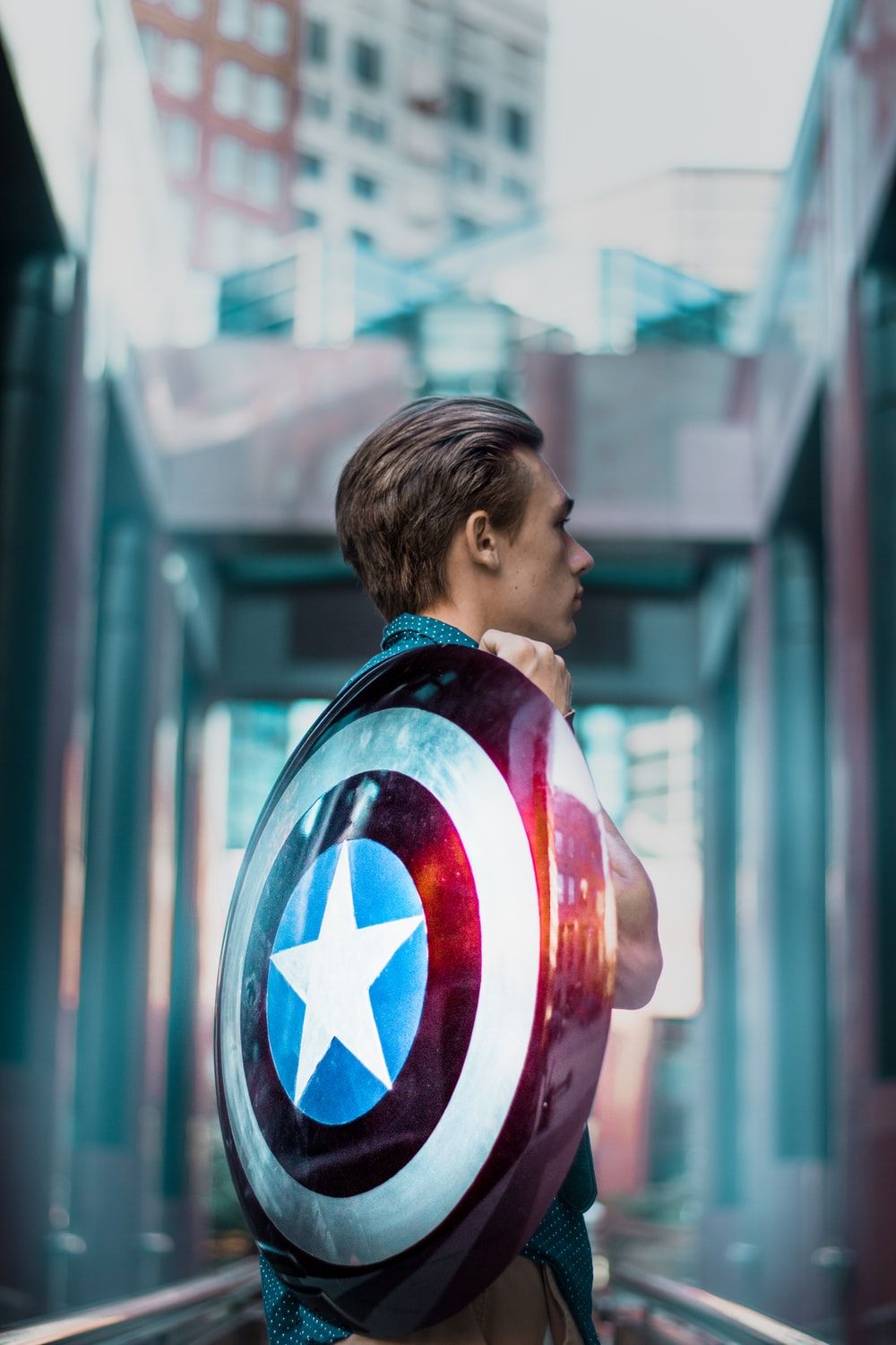 man carrying Captain America's shield photo