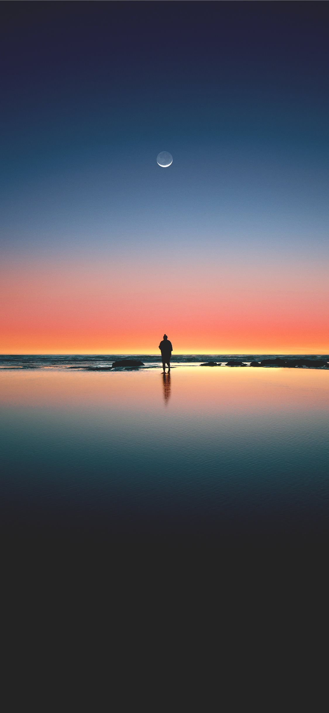 silhouette of man standing on seashore iPhone 11 Wallpaper Free Download