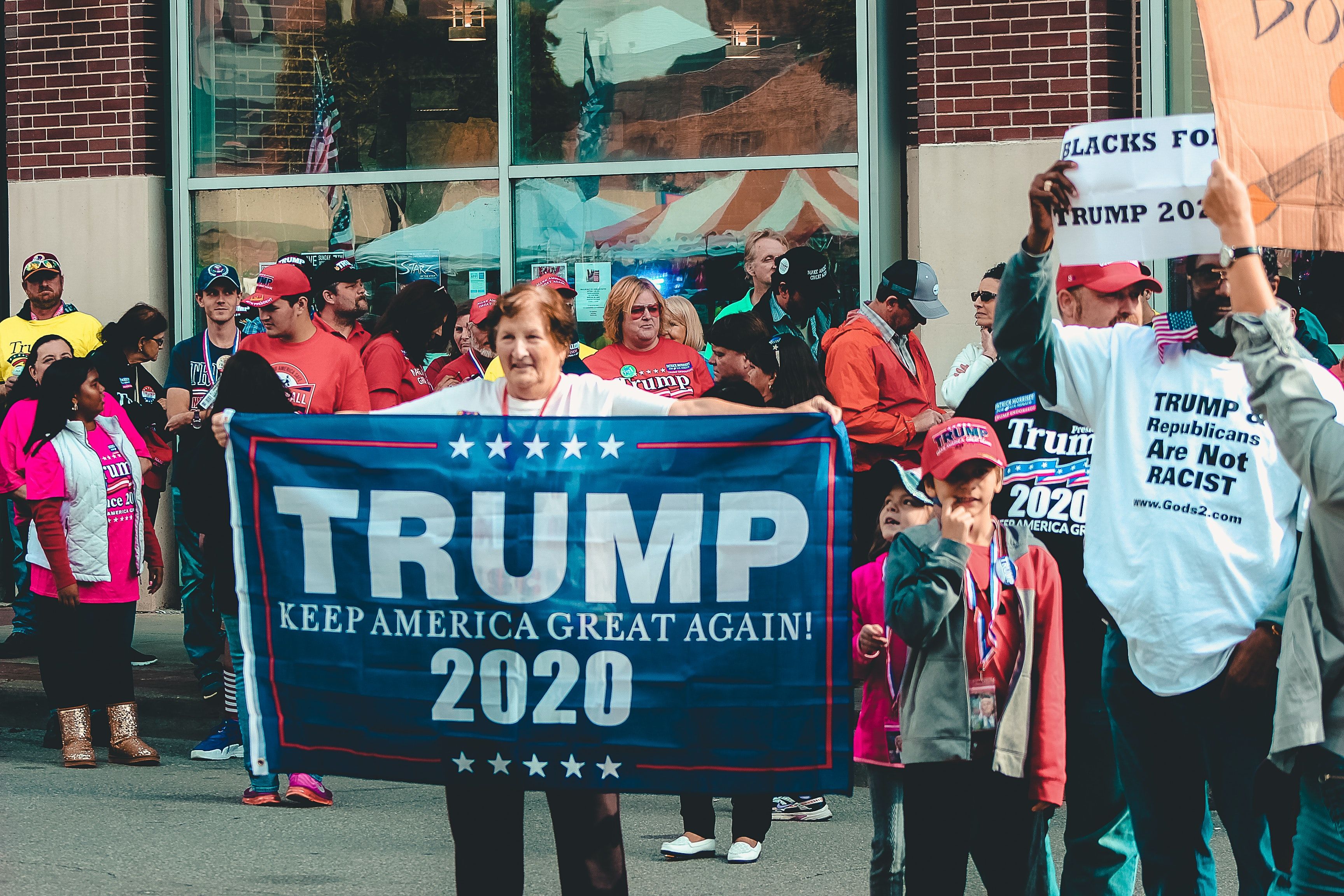 Woman Holding Trump Keep America Great Again 2020 Banner · Free