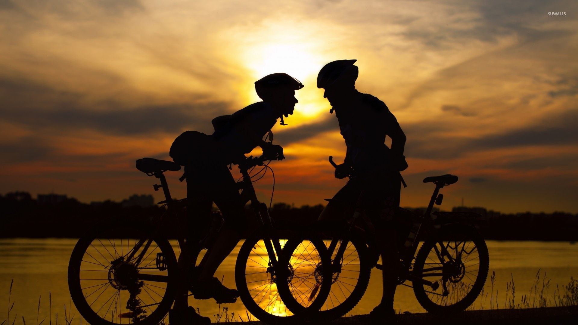 Couple on bikes at sunset wallpaper wallpaper