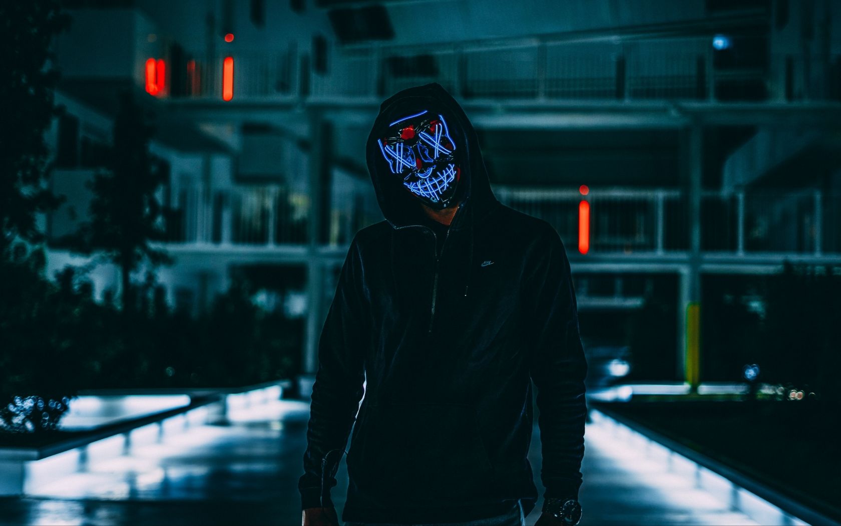 Download A Person Wearing A Neon Mask With A Hoodie Wallpaper