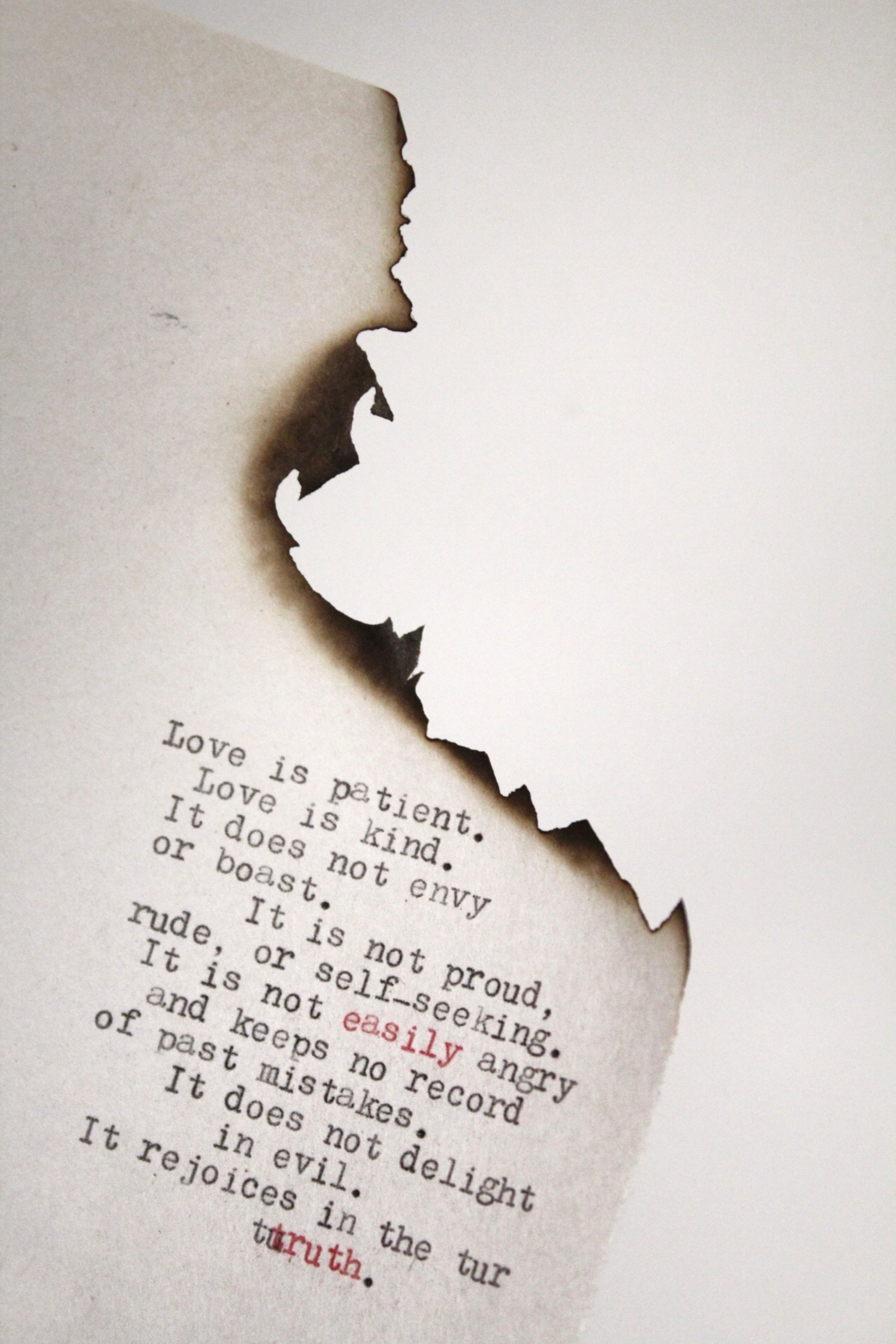 Love is patient Love is kind printed on burned paper photo