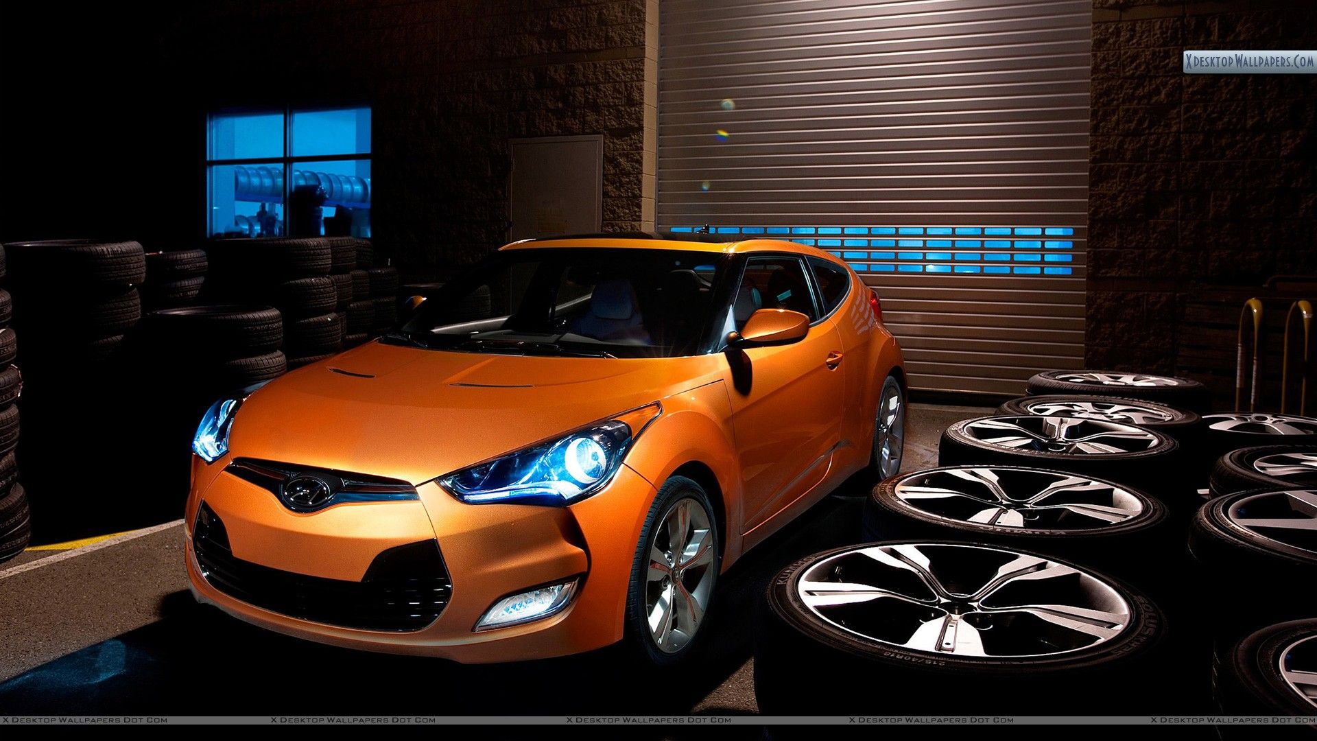 Hyundai Veloster in Garage with Lots of Tyres Wallpaper