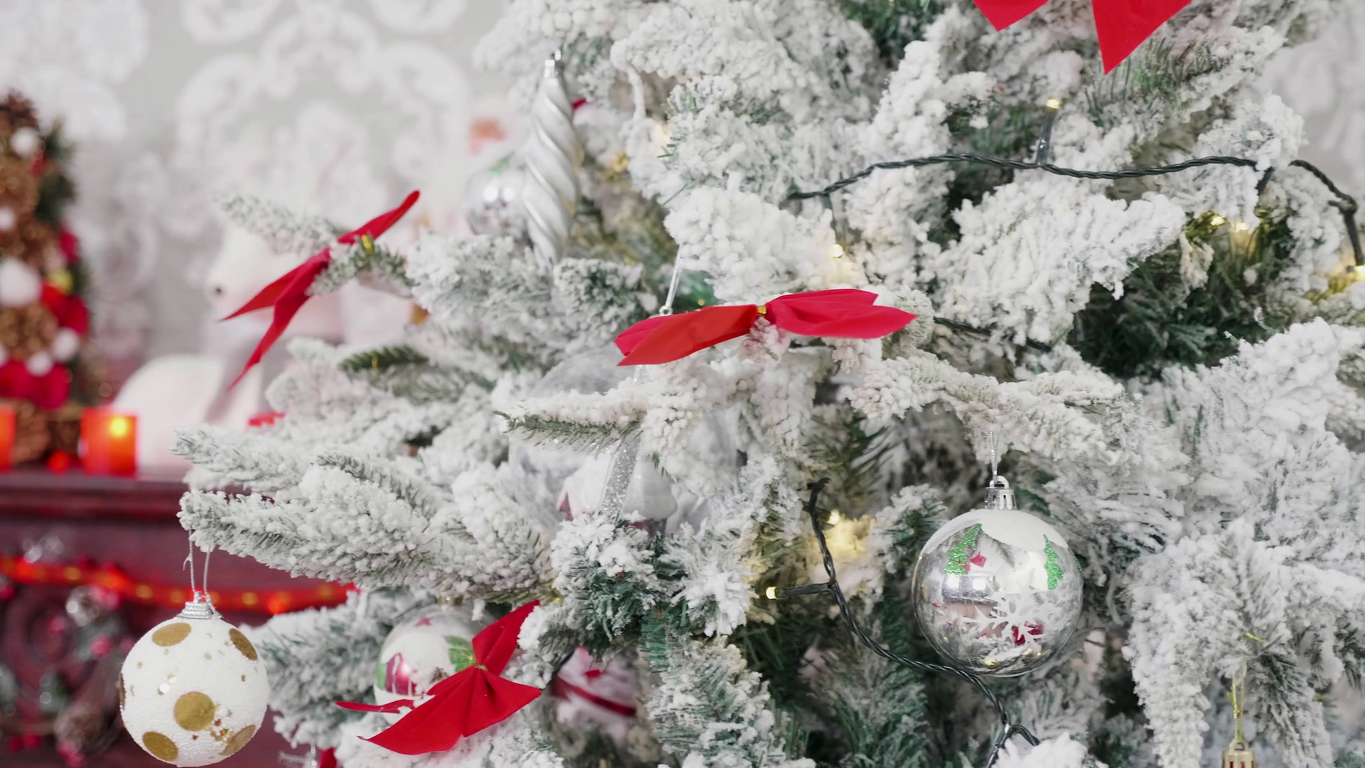 Christmas Morning In Cozy Room a stock footage presenting a close up dolly shot of white Christmas tree and a fireplace. There are different Christmas decorations on the chimney. The