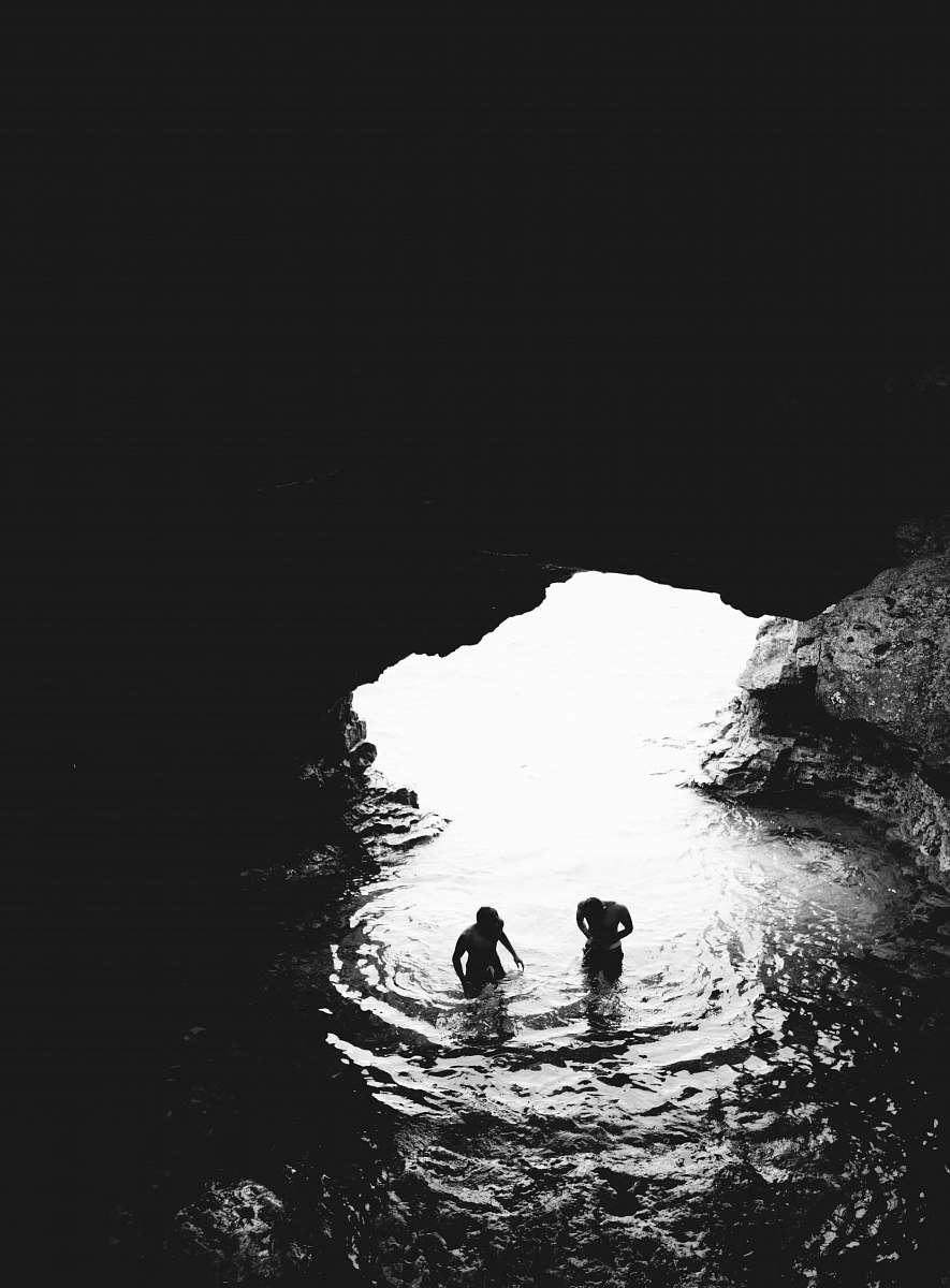 ✅ iPhone Wallpaper Grayscale Photo Of Two Men In Cave With Body Of Water iPhone Background Image