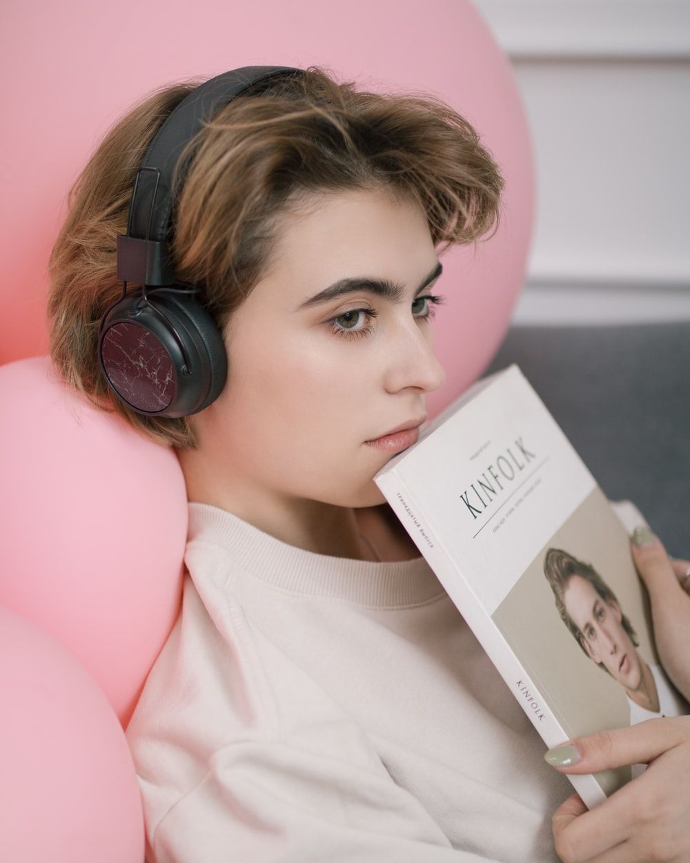 woman listening on black headphones photo