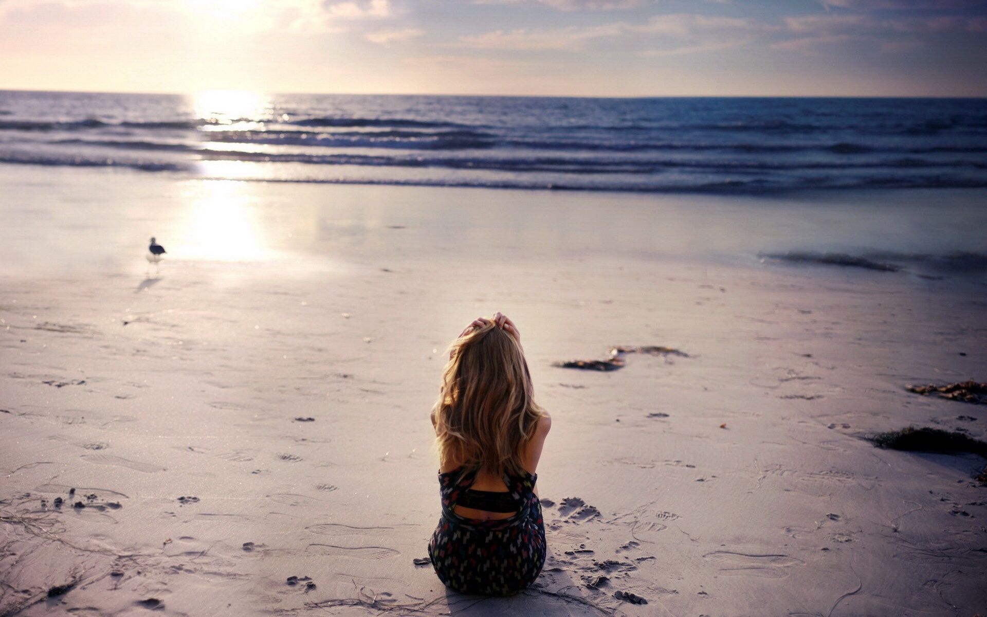 Woman sits alone on the beach. Sunset girl, Beach, Lonely girl