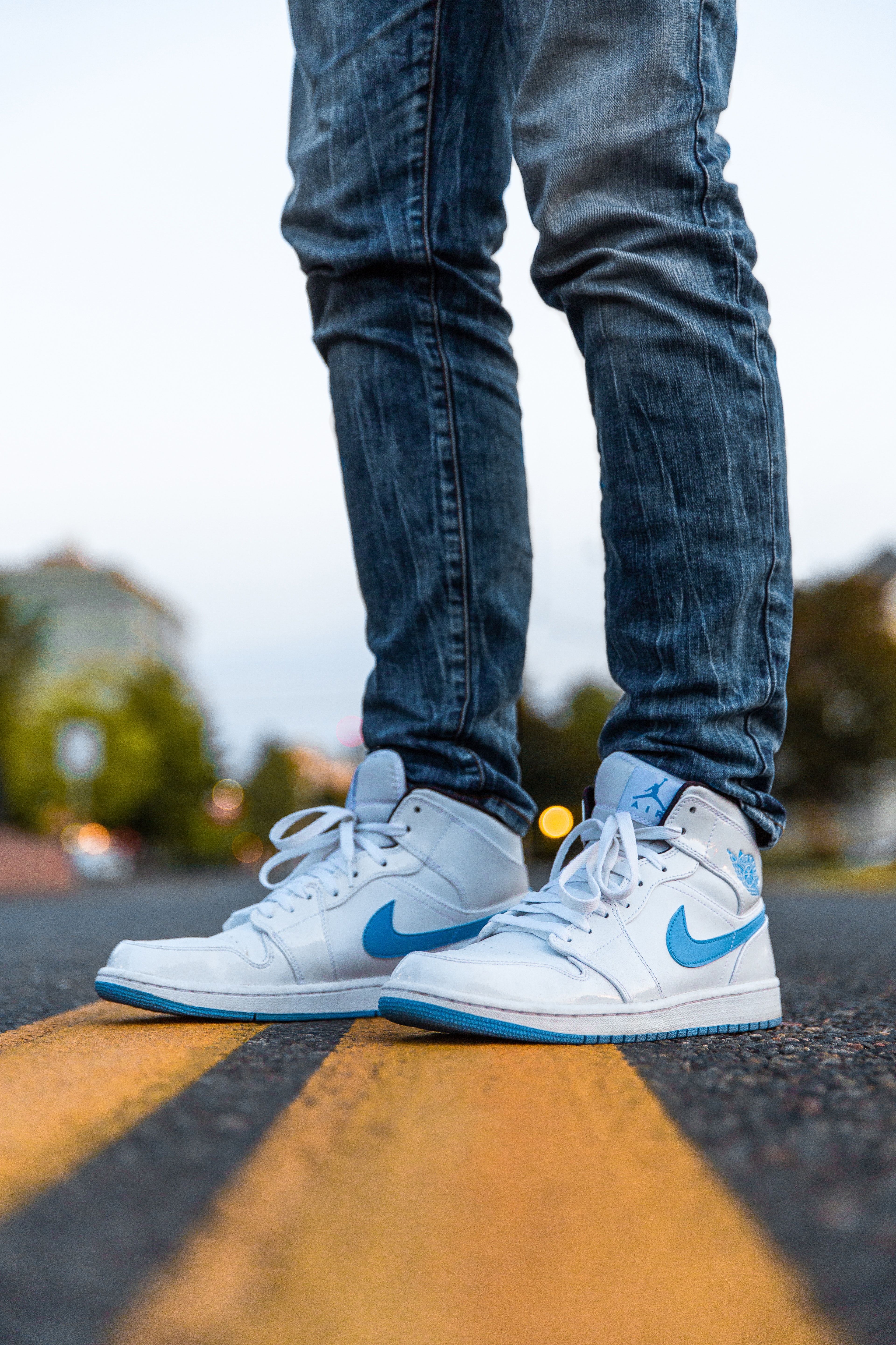 Person Wearing White And Blue Air Jordan 1's · Free