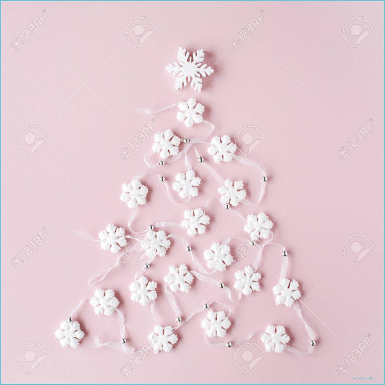white christmas tree decoration on pink background. christmas