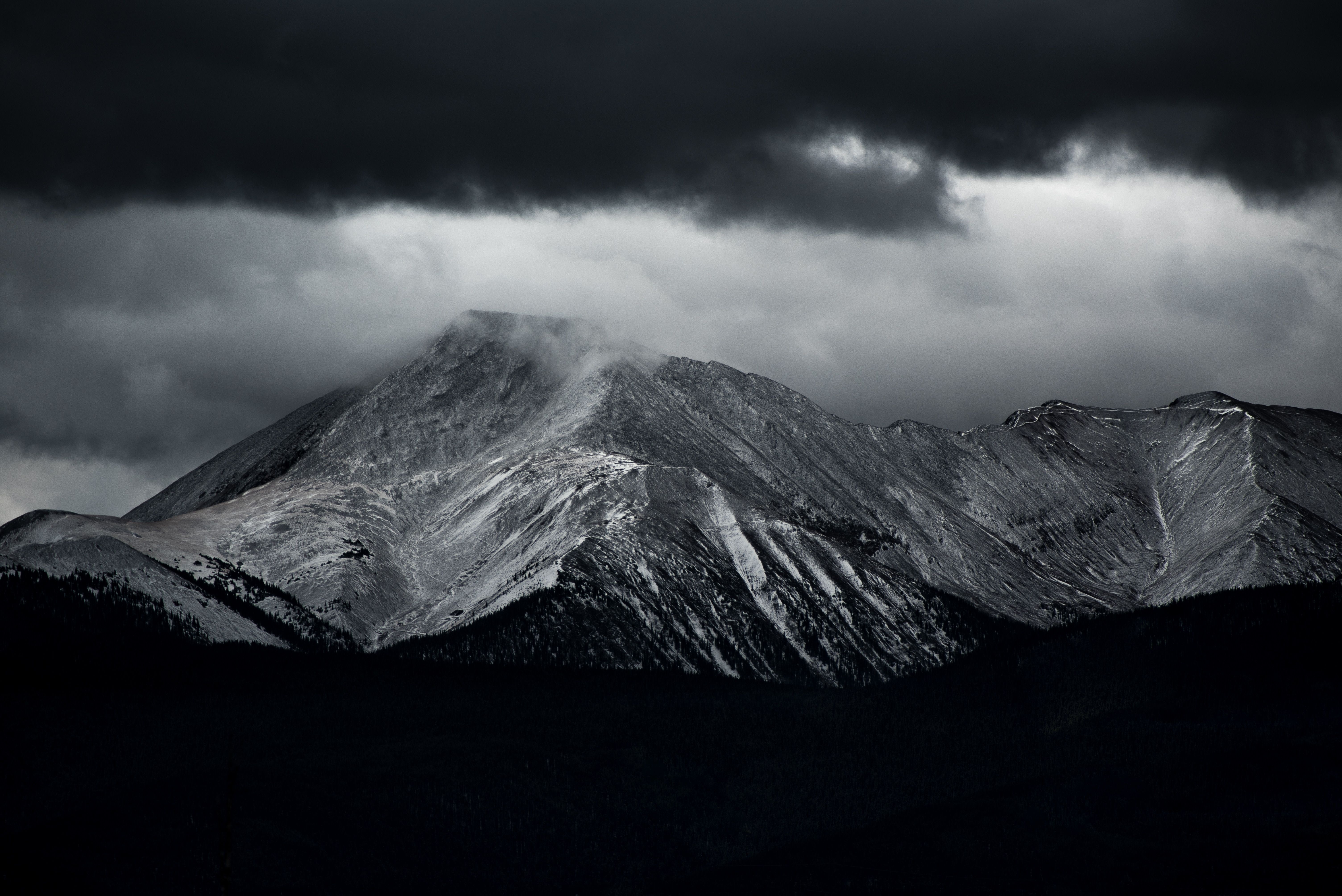 Snow Capped Mountain Range Under Nimbus Clouds Shown Free Image