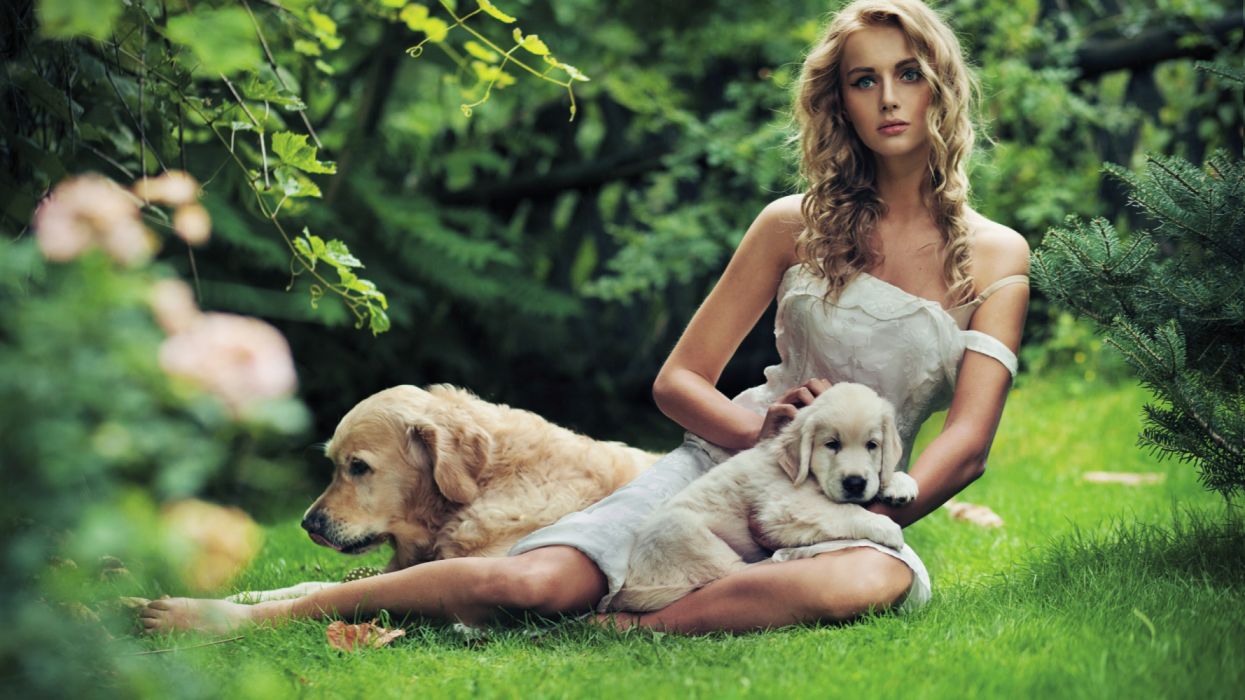 Beautiful girl with a dog in the grass wallpaperx1440