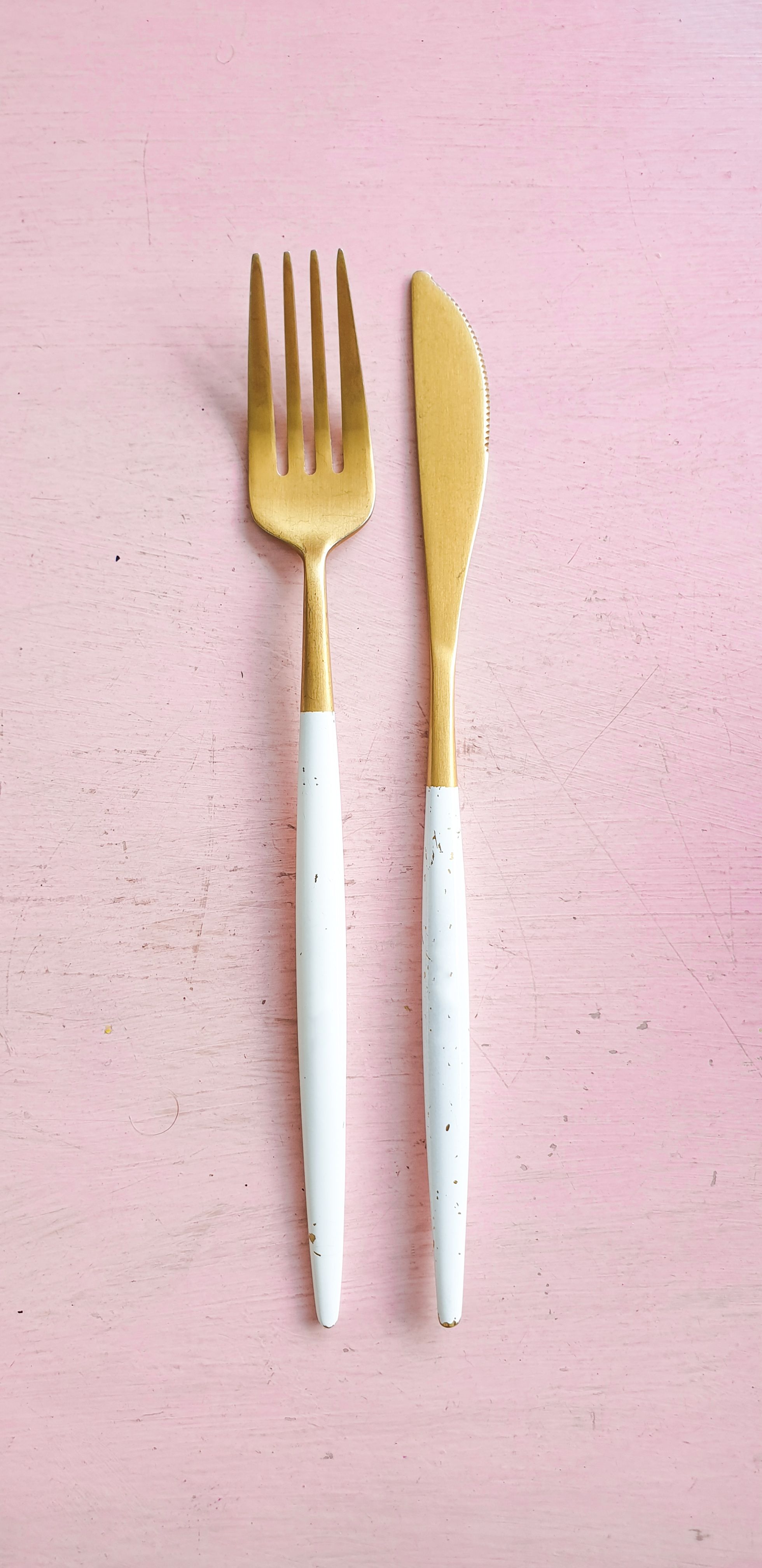 Pair Of White And Brass Fork And Breadknife Photo