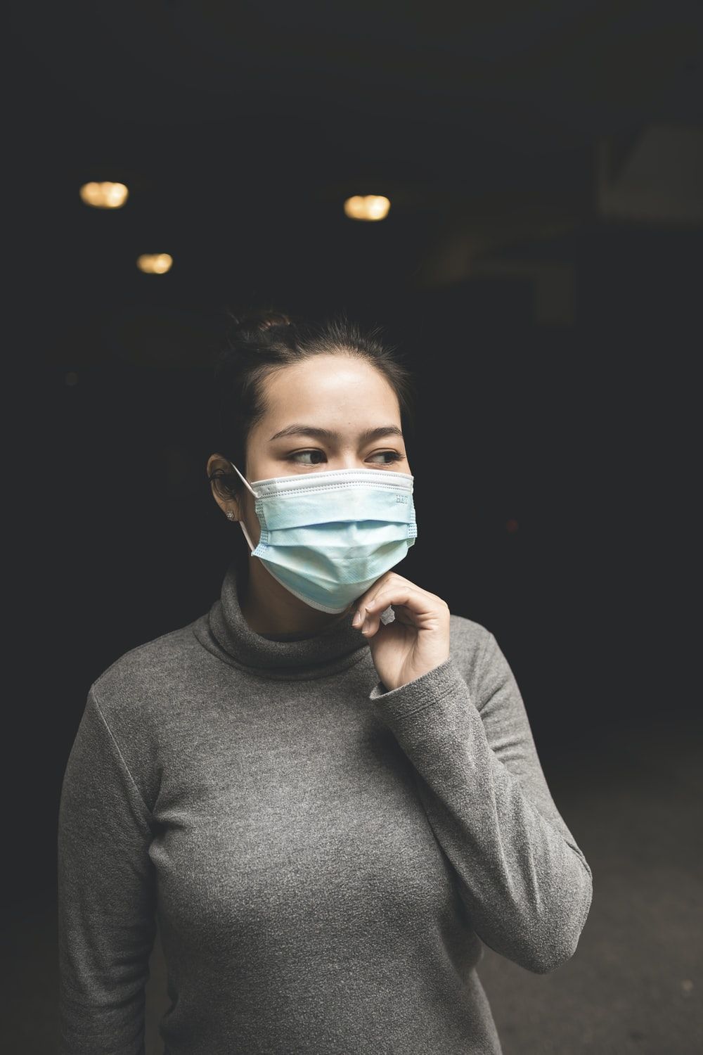 Woman Wearing Teal Mask And Gray Turtle Neck Shirt Photo