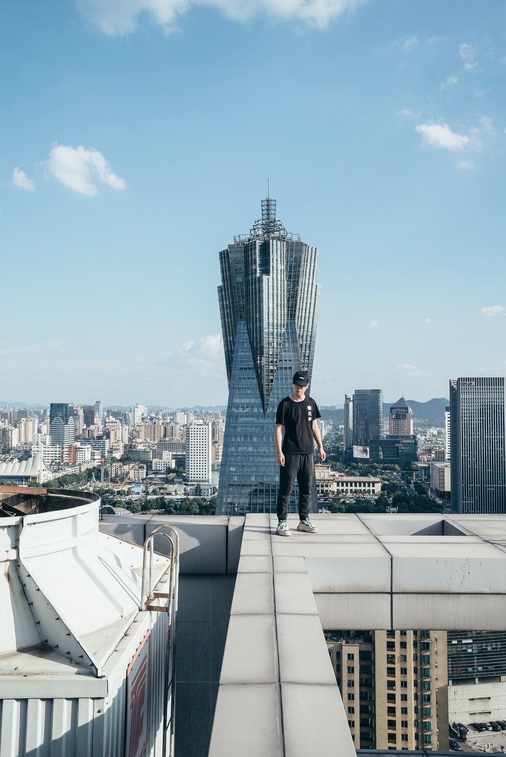 man standing on top of a building photo