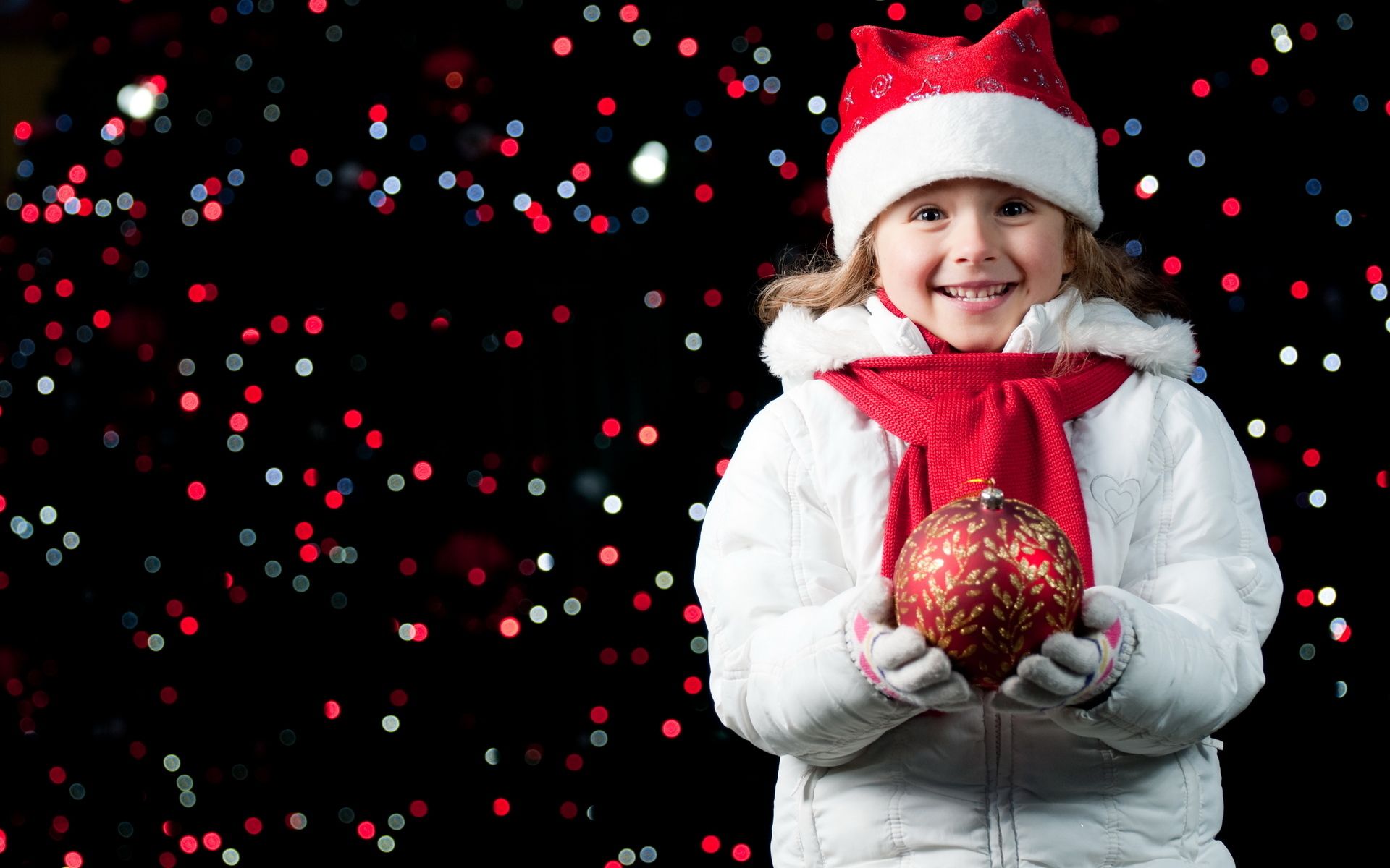Pretty Girl Holding A Christmas Ball Wallpaper
