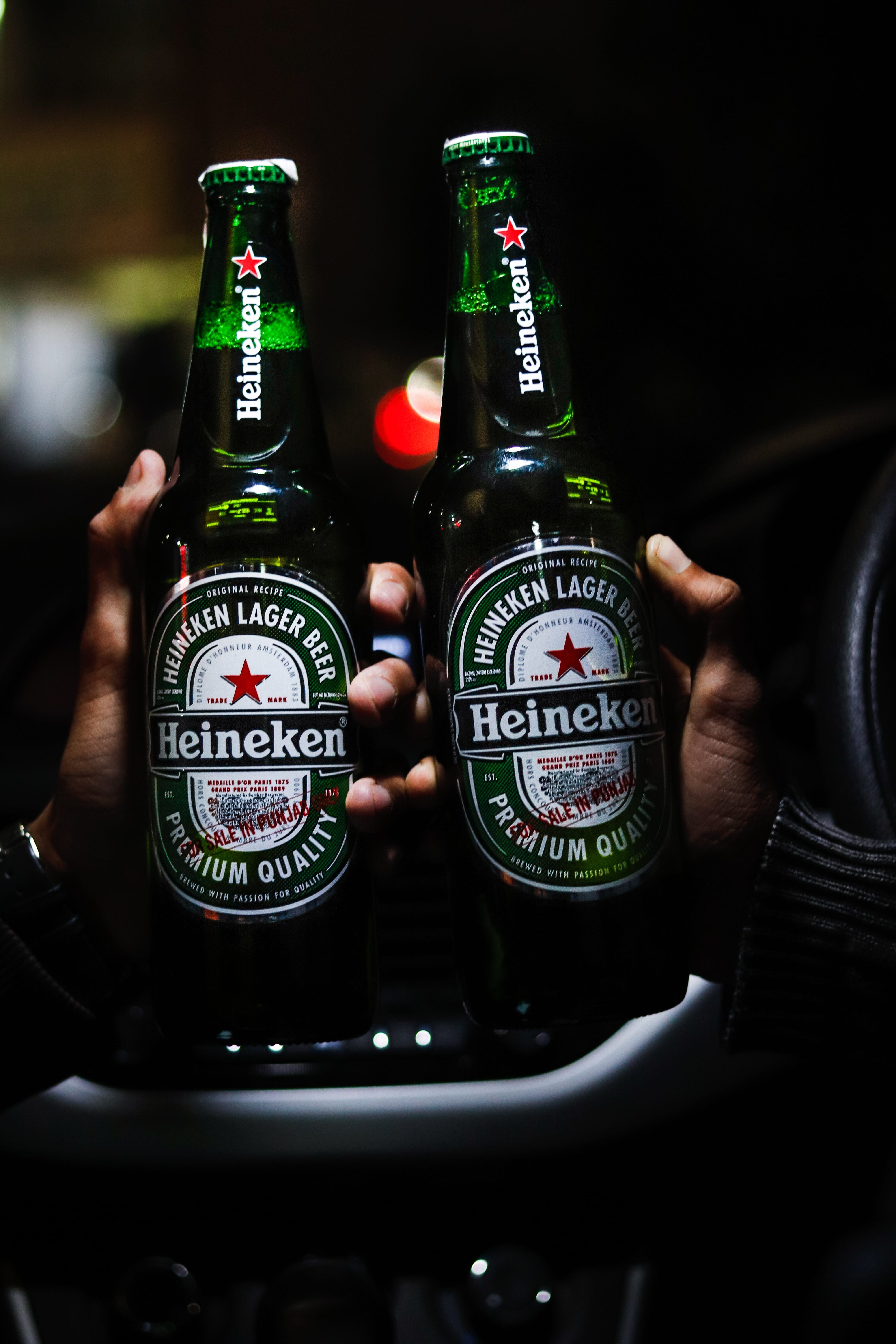 two #beer #bottles #of #heineken #green #beverages #car #city #bokeh #night #carholding #holding #in #hand K #wallpaper #hdwall. Heineken, Beer, Beer wallpaper