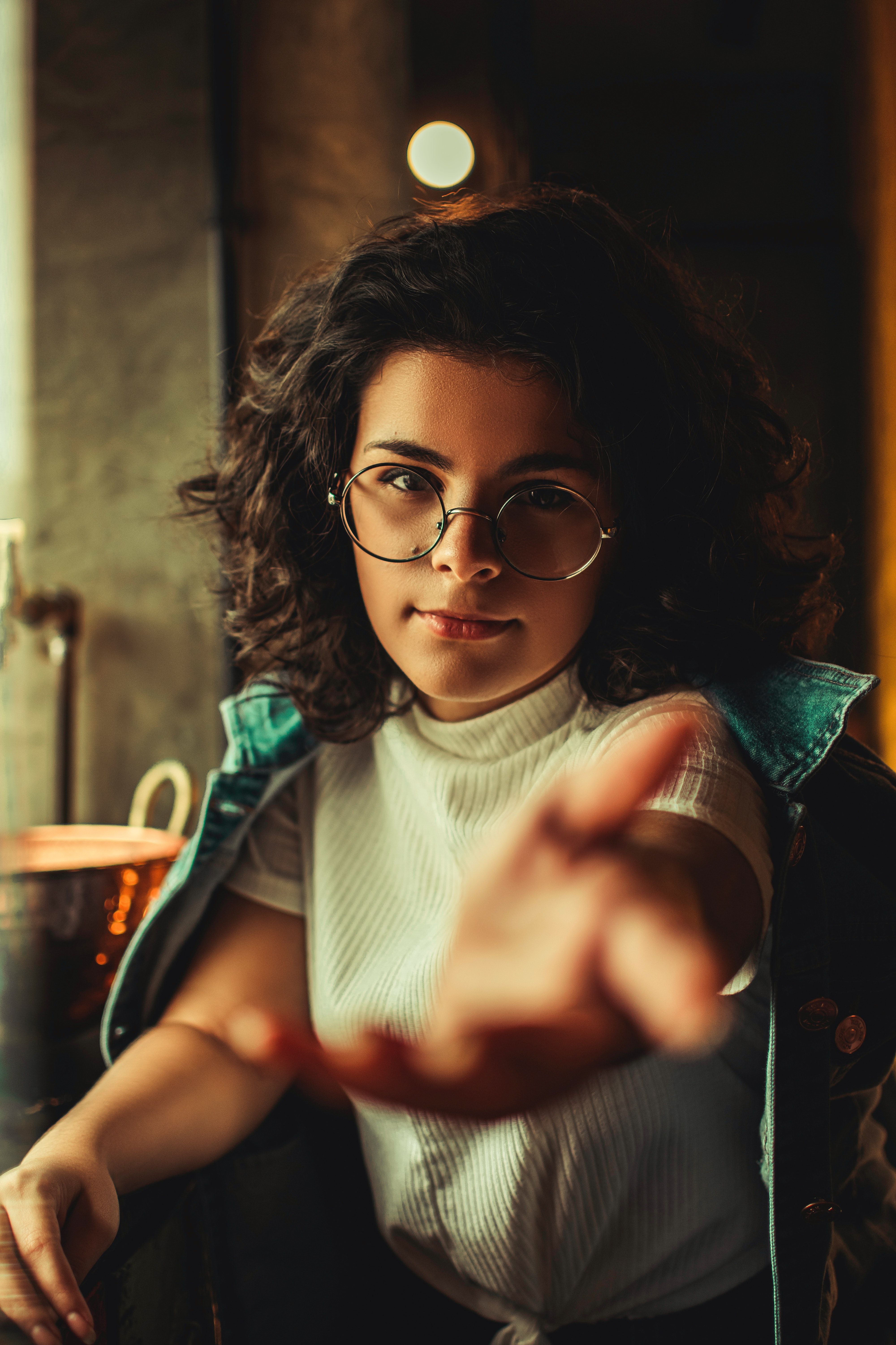 Woman With Curly Hair And Eyeglasses Extending Her Arms · Free