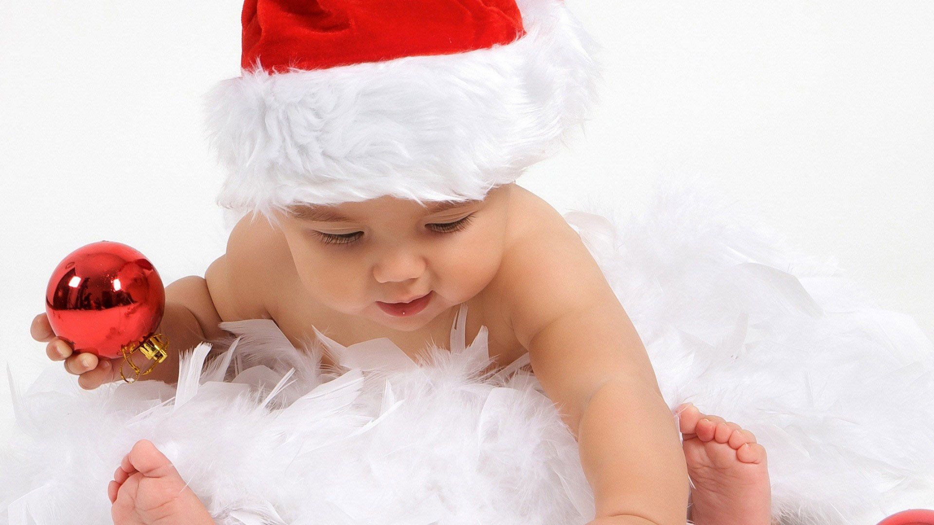 Cute Baby Is Wearing Santa Claus Cap Having Christmas Decoration Red Ball In Hand HD Cute Wallpaper