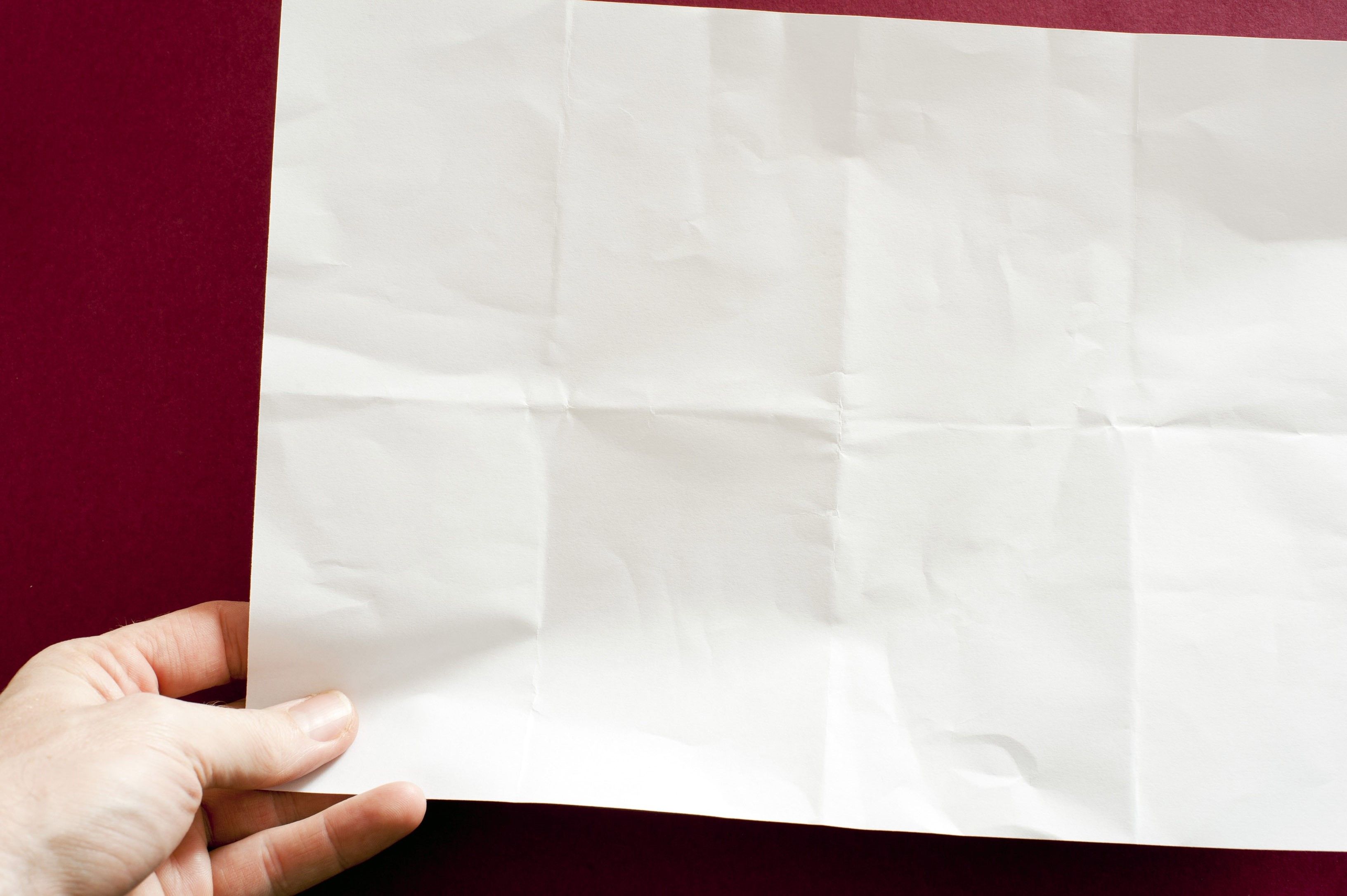 holding a blank paper. Free background and textures
