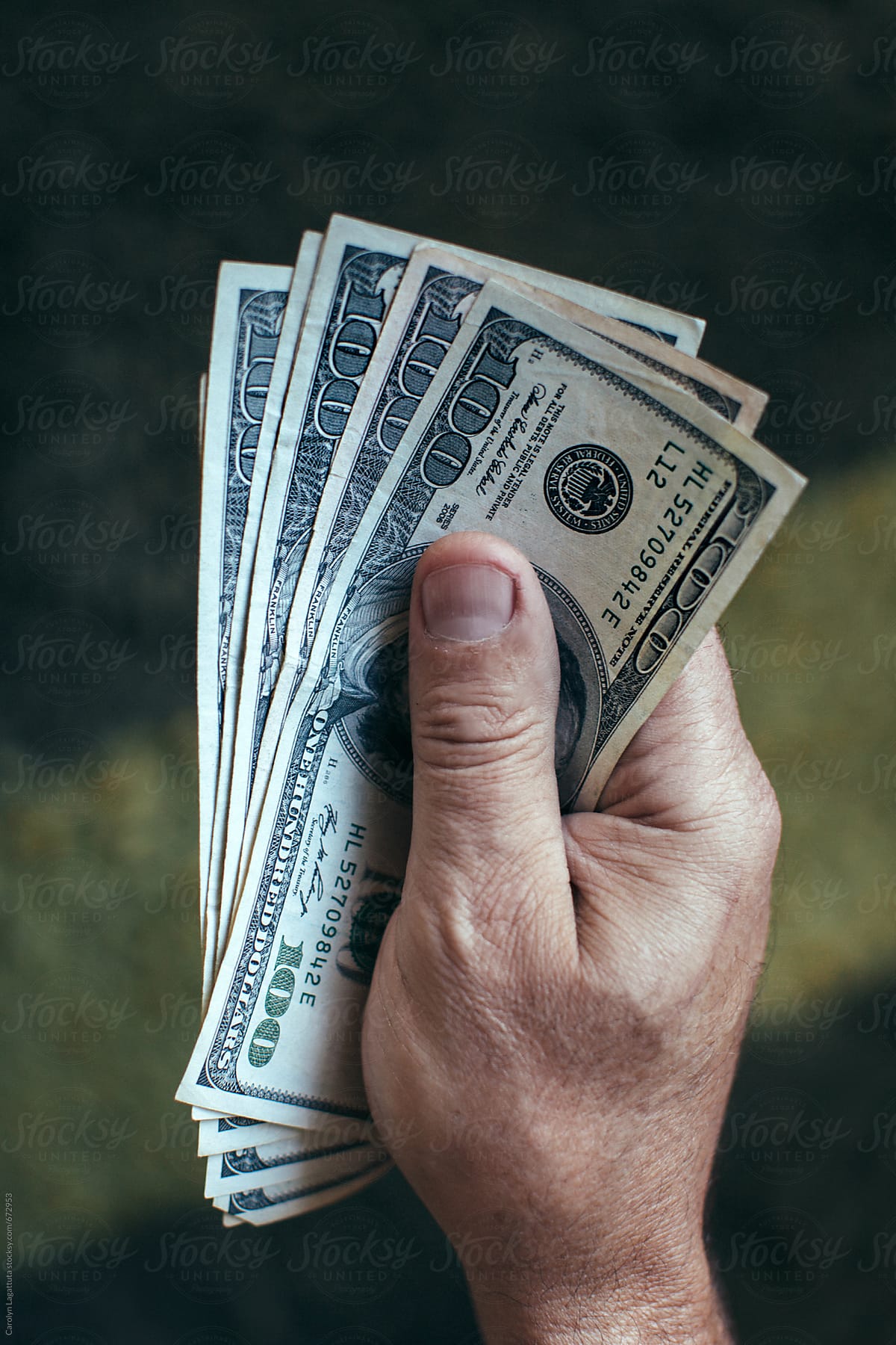 Man holding a large stack of money