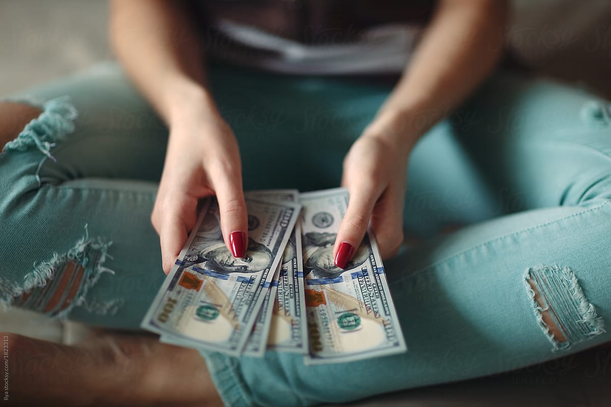 Woman holding dollars by Ilya, Woman