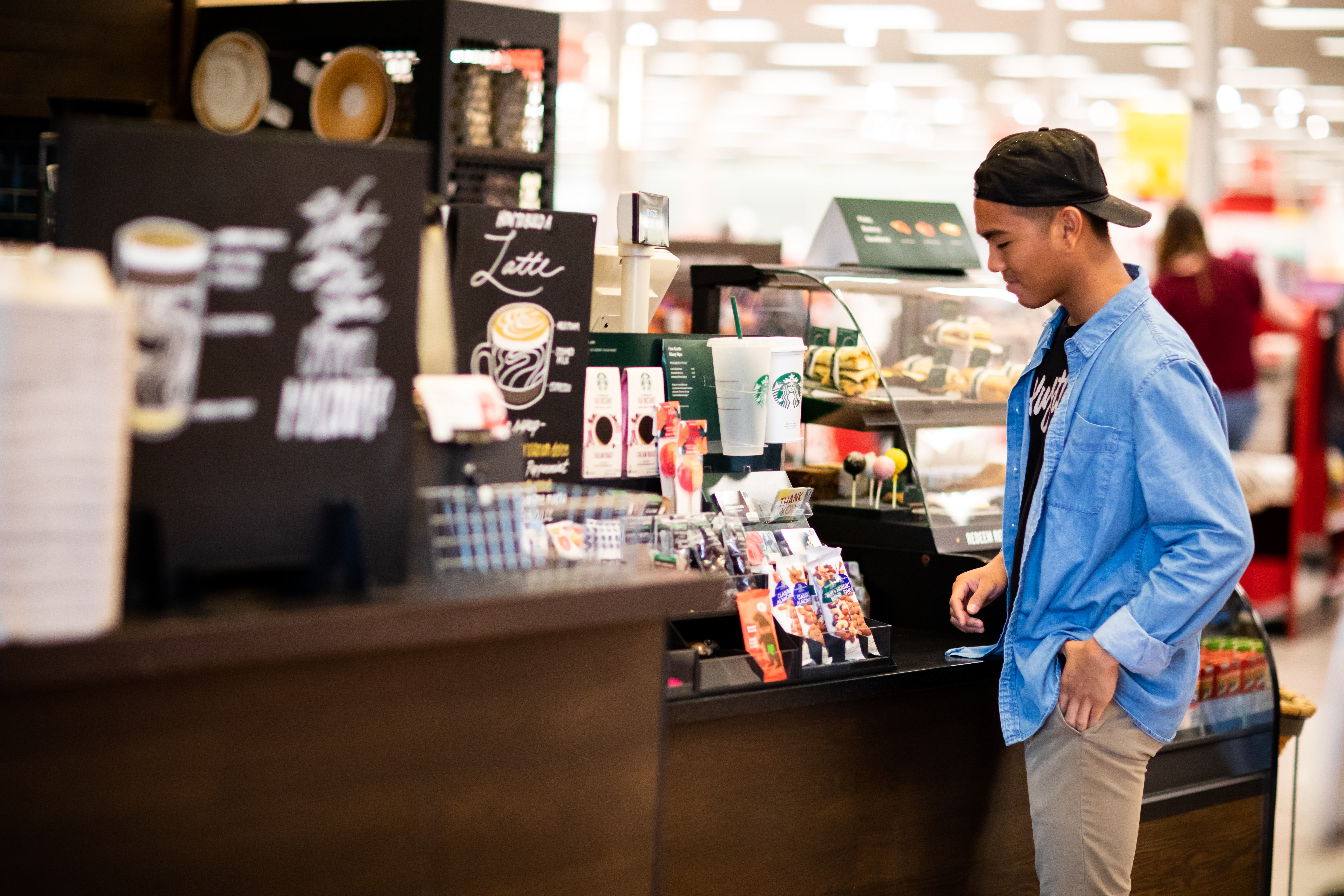 man standing in front cashier photo