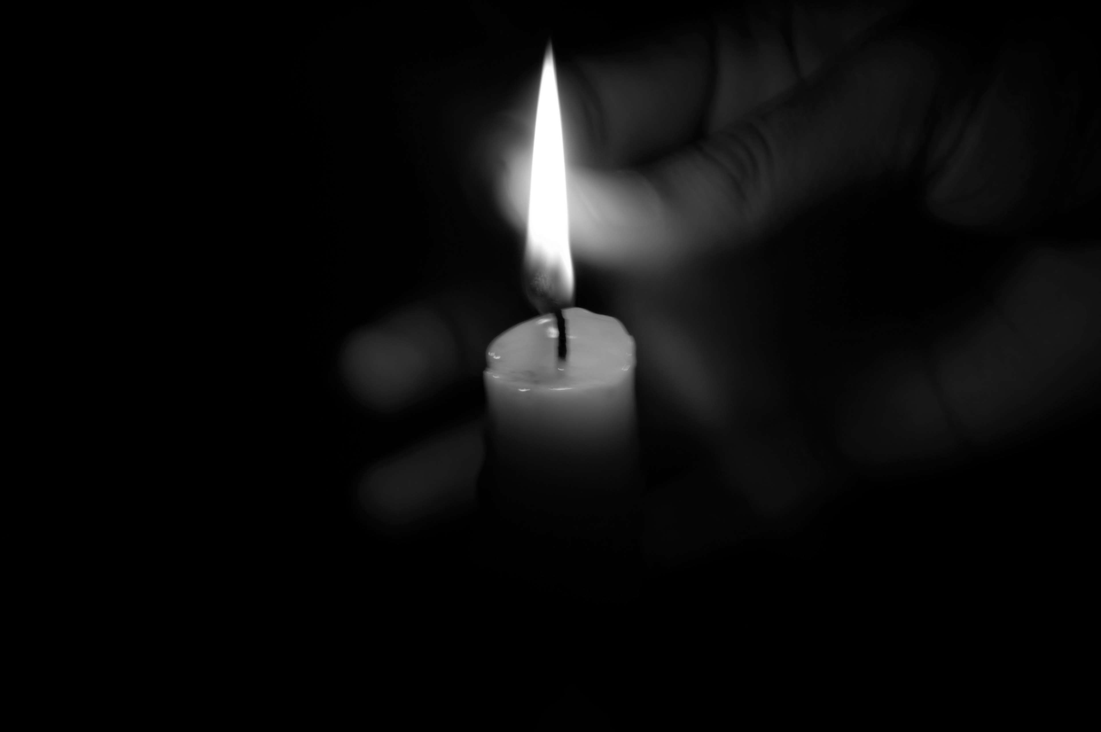 black and white, candle, dark, fire, hand, light, shadow 4k wallpaper
