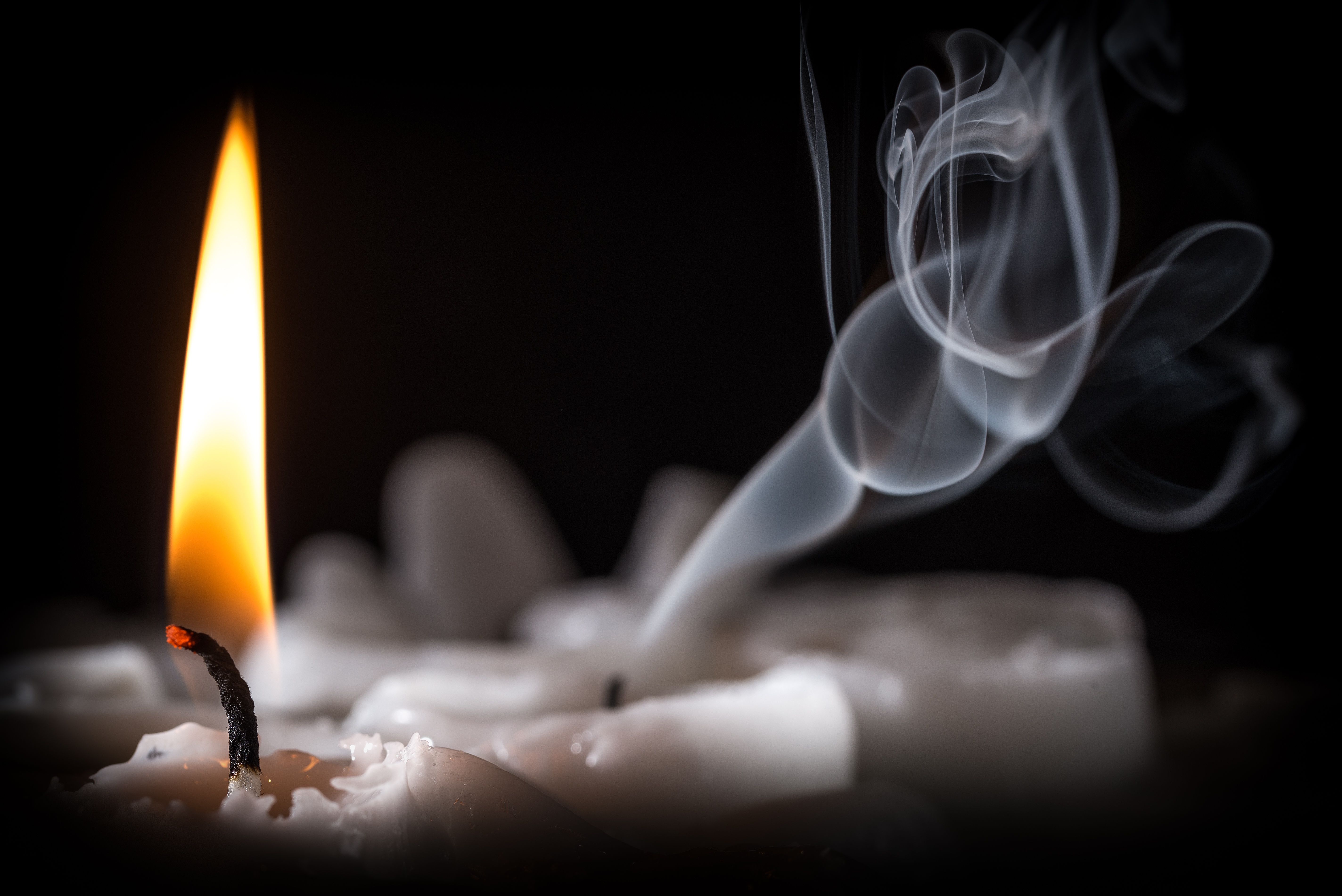 Fire burning candle with smoke on a black background Desktop wallpaper 1366x768
