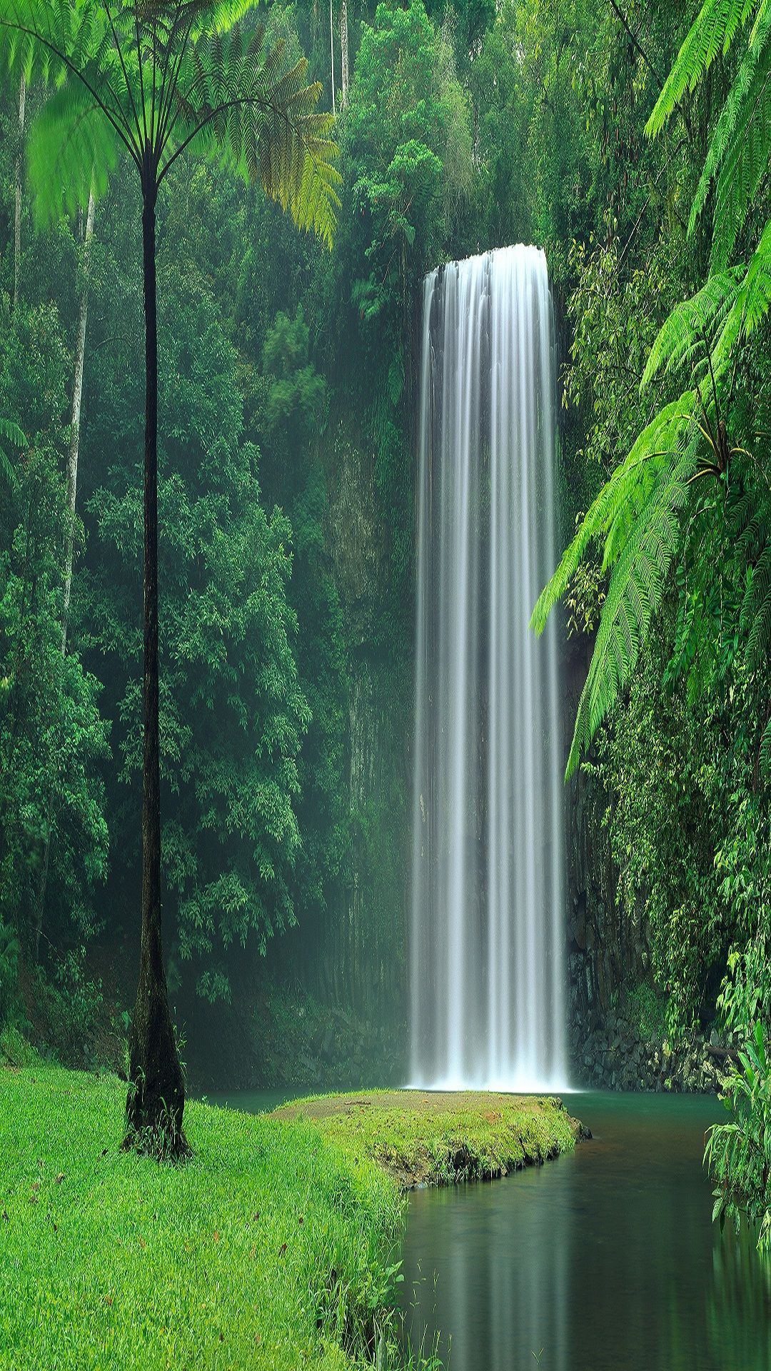 Download An aerial view of a beautiful waterfall cascading into a  magnificent lake Wallpaper  Wallpaperscom