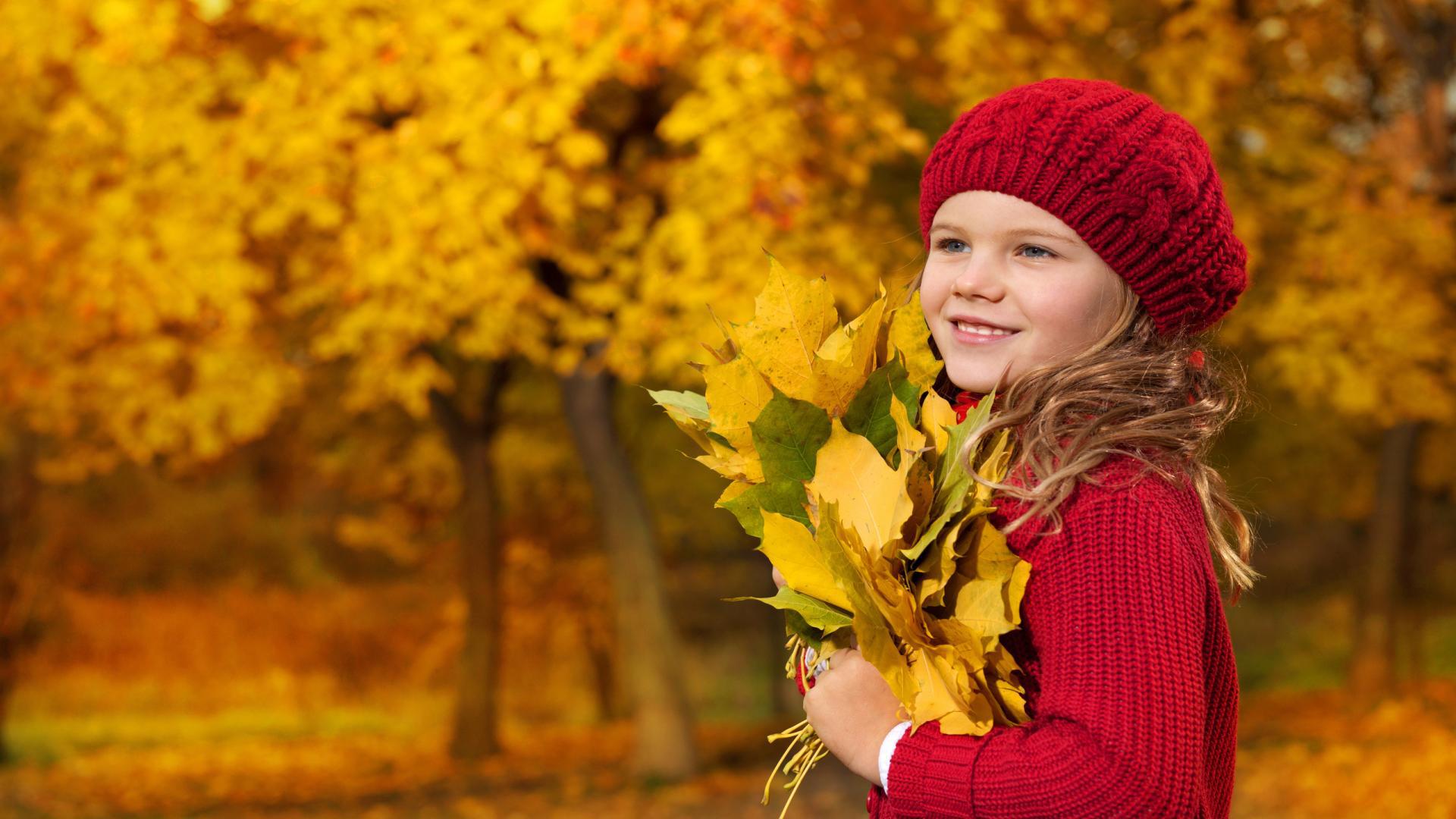 Cute baby girl is holding autumn leaves wallpaper and image, picture, photo