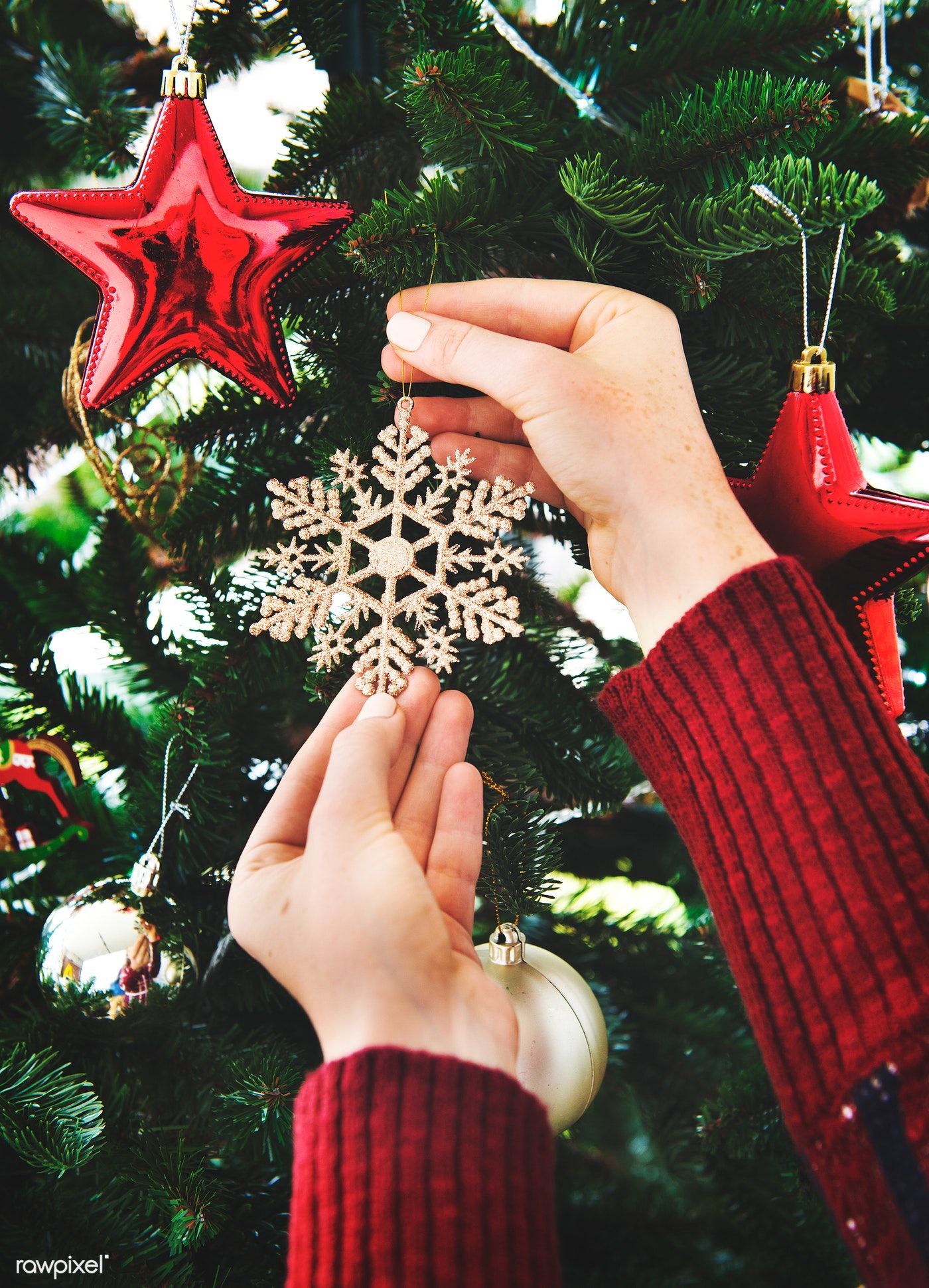 Putting a snowflake decoration on the Christmas tree. Christmas aesthetic, Christmas wallpaper, Xmas decorations