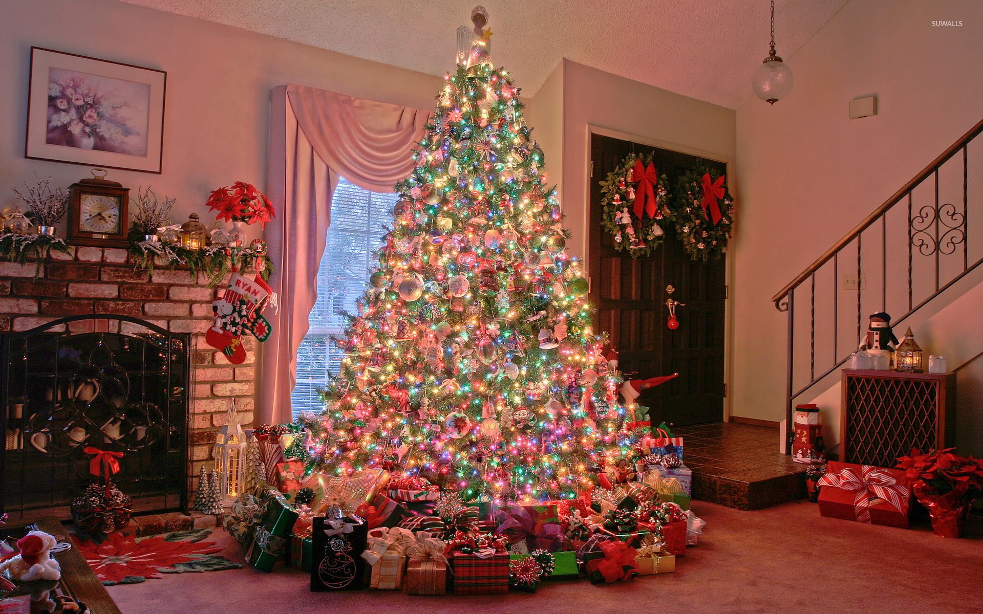 Many gifts under the glowing Christmas tree wallpaper wallpaper