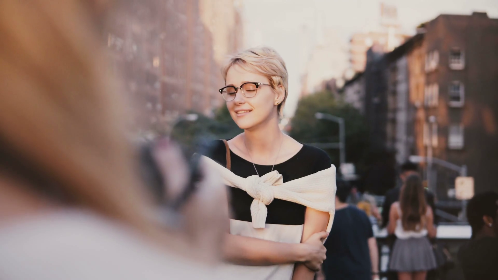 Happy peaceful European blonde girl with short hair in eyeglasses smiling at photohoot outside, posing at camera. Stock Video Footage