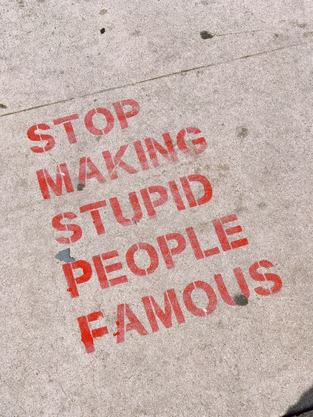 stop making stupid people famous signage photo