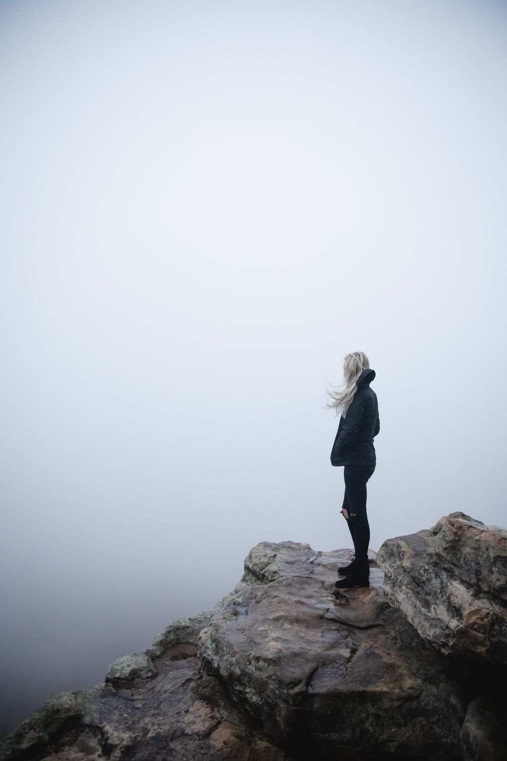 woman standing on cliff photo