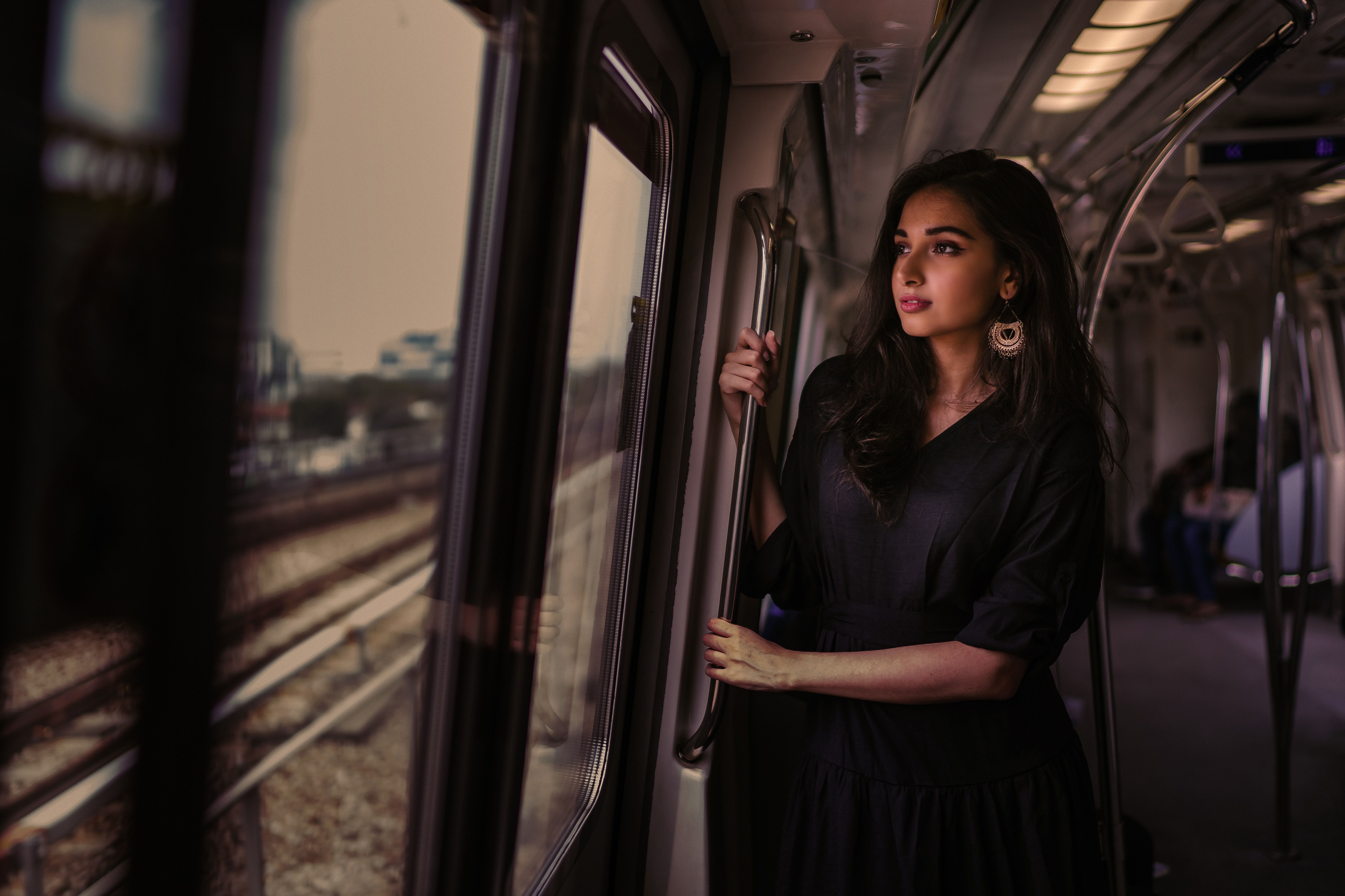 Women Standing In Train Holding Metal Rail While Looking Outside 5k 1440P Resolution HD 4k Wallpaper, Image, Background, Photo and Picture