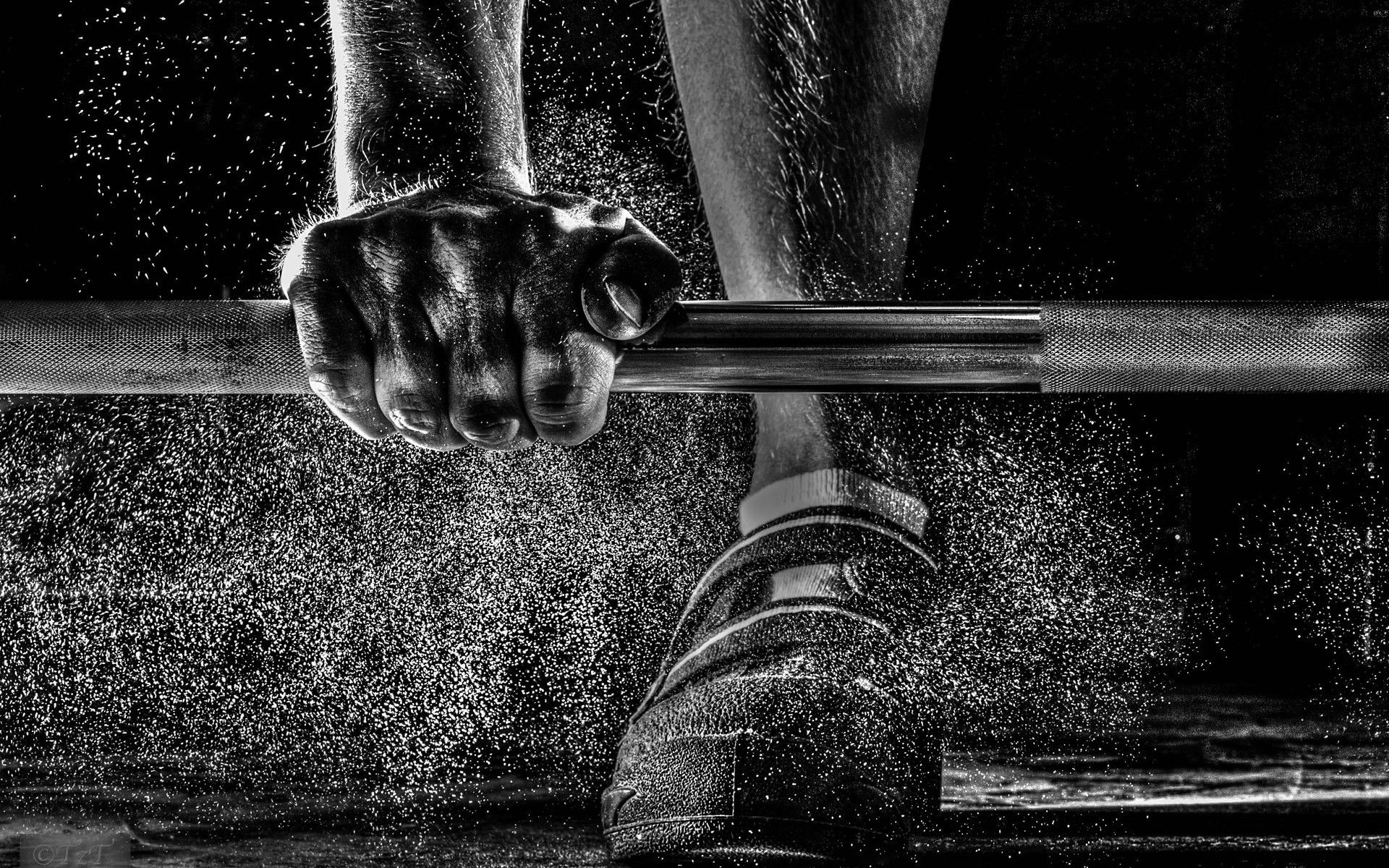 A Man Training Weight Lifting Barbell With Dust Flying To Fitness