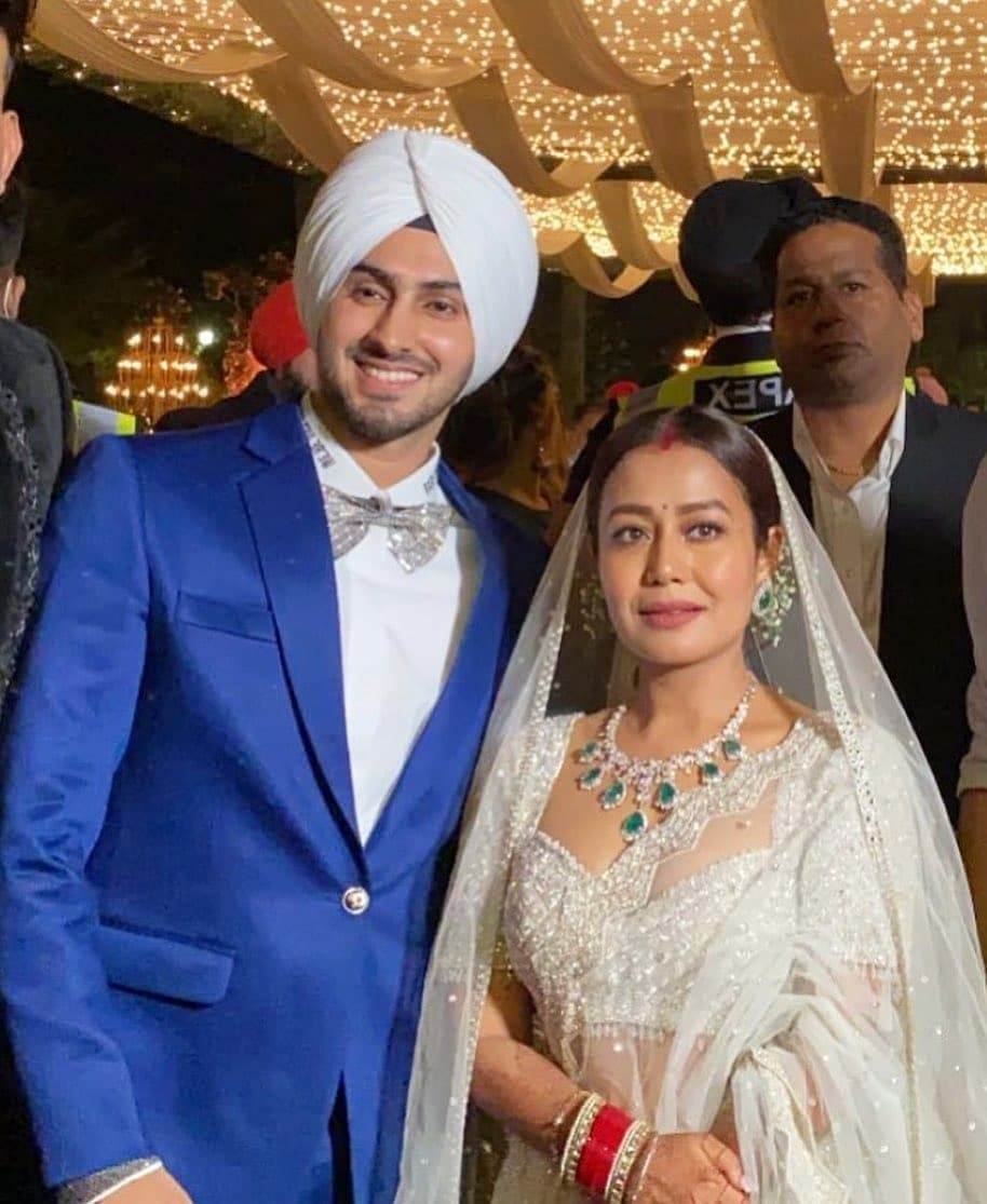 Neha Kakkar Rohanpreet Singh wedding reception. [VIDEO] Neha Kakkar opts for stunning white lehenga for wedding reception, husband Rohanpreet Singh leaves her blushing