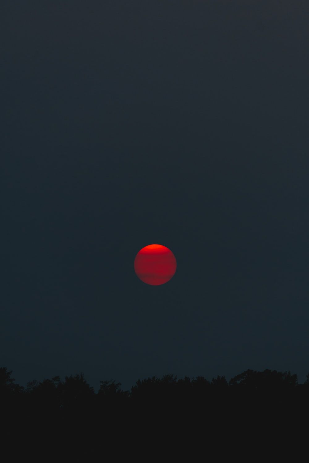 red moon at night photo