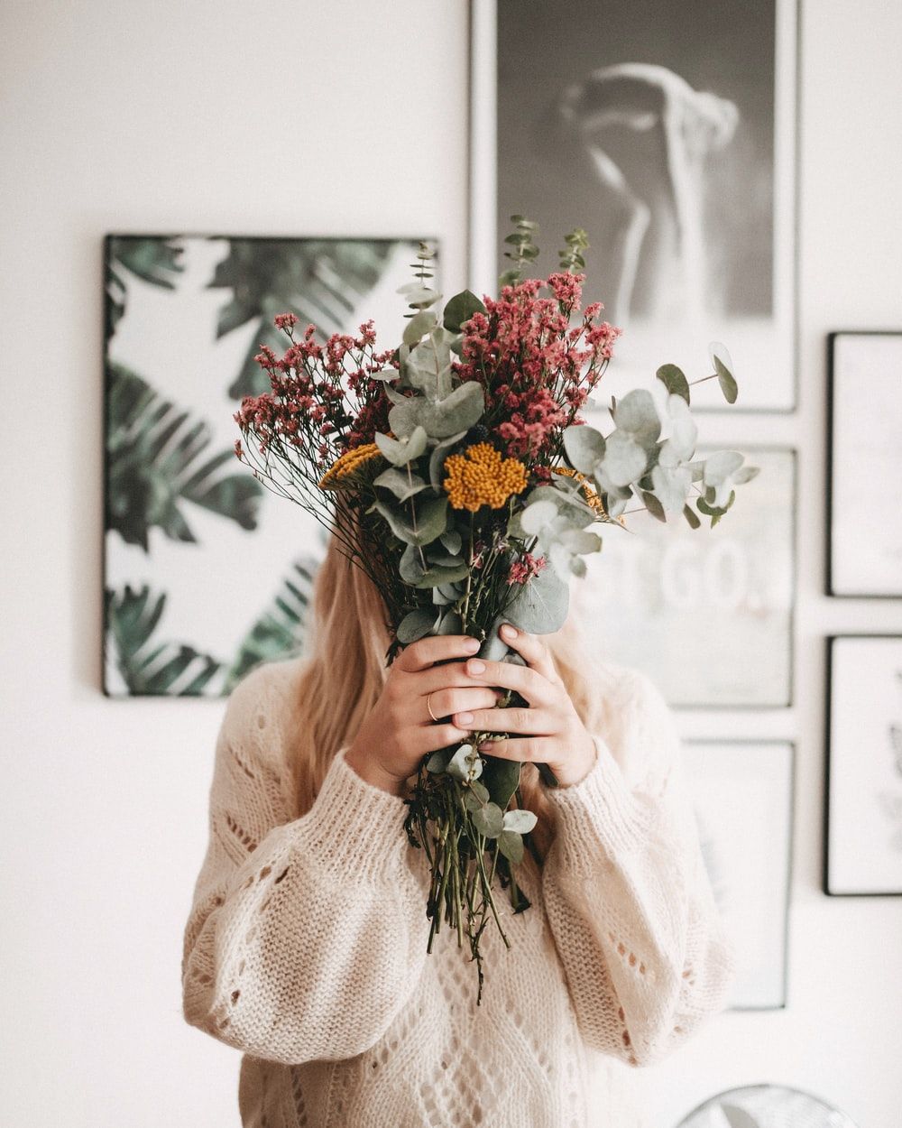 woman hiding her face using bouquet photo