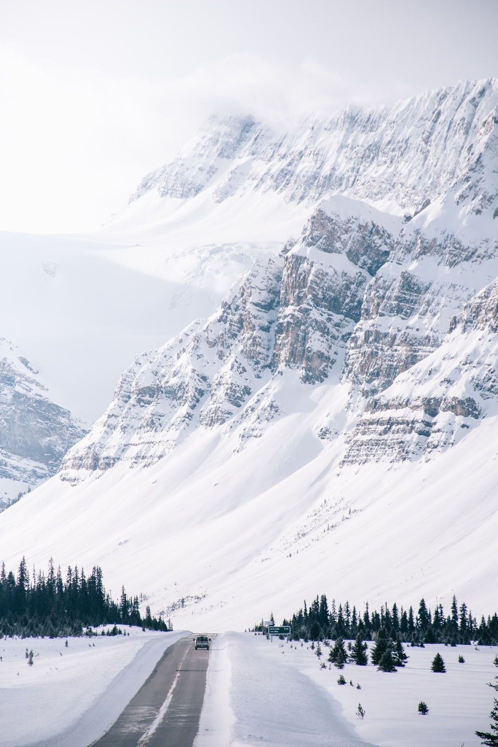 white snow covered hills and road side photo