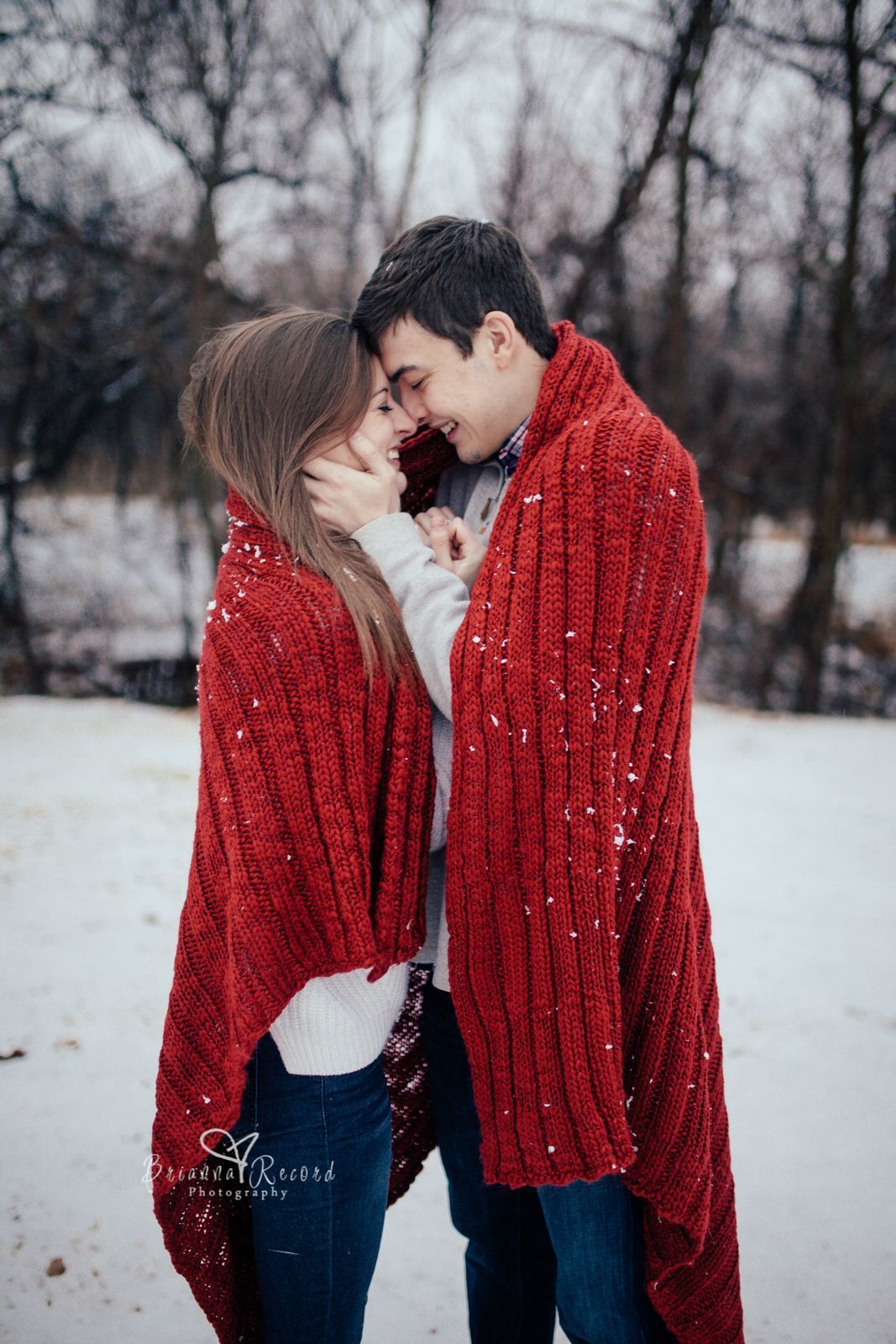 Outdoor portrait. Young beautiful happy smiling couple posing on street.  Models hugging, looking at candy canes, wearing stylish winter clothes.  Snowfall. City lifestyle. Copy, empty space for text Stock Photo | Adobe